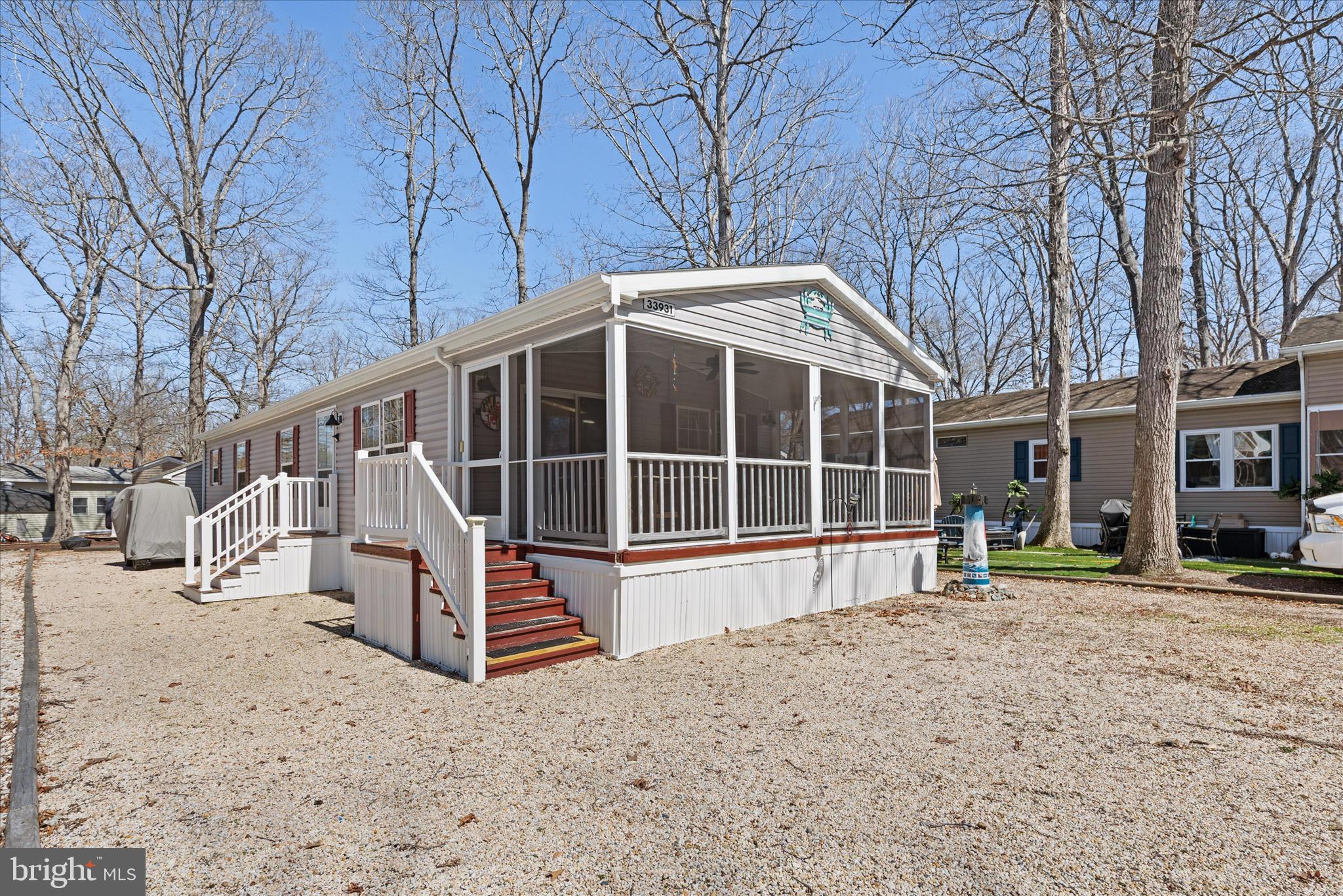 Enjoy the ease of coastal living in this beautifully updated, partially furnished 3-bedroom, 2-bath home located in the sought-after community of Sun Retreats.  Ideally situated just a few sites from the boat canal and close to the clubhouse, pool, marina, and on-site restaurant, this home offers both convenience and a true waterfront lifestyle, with the option to purchase a boat slip through the community.

A wide screened porch stretches across the front of the home, creating a welcoming space to relax and enjoy the coastal breeze. Inside, the open-concept main living area features vaulted ceilings, light neutral tones, and updated Pergo flooring that enhance the bright, spacious feel. The living, kitchen, and dining areas flow seamlessly together, making it perfect for entertaining and everyday living.

The kitchen is both stylish and functional, offering a center island with seating and storage, a generously sized stainless-steel refrigerator with water dispenser and icemaker, and updated fixtures. Down the hall, a laundry room with a secondary exterior door provides added convenience and can easily serve as a mudroom.

The home offers two guest bedrooms and a full hall bath, while the primary suite is privately located at the rear. This inviting retreat features vaulted ceilings, two walk-in closets, and an attached bath. Upgraded ceiling fans throughout the home add comfort and a modern touch.

Sliding glass doors lead from the living room back to the screened porch, while the rear Trex deck platform with added lighting provides the perfect setting for evening gatherings, grilling, or relaxing under the stars. Additional storage is available with both a main shed and a portable shed.

Extensive recent upgrades provide peace of mind, including a new HVAC system and furnace, a brand-new refrigerator, updated shed roof, new flooring, upgraded electrical work, and replaced plumbing fixtures and water lines.

After park approval, residents enjoy low monthly ground rent that includes trash collection and access to an impressive array of amenities, including a pool, clubhouse with fitness center, sports courts, playground, dog park, marina store, and boat launch with access to the Indian River Bay and beyond.

With its thoughtful upgrades, furnished convenience, and prime location near the water, this home is ready for you to start enjoying coastal living right away.