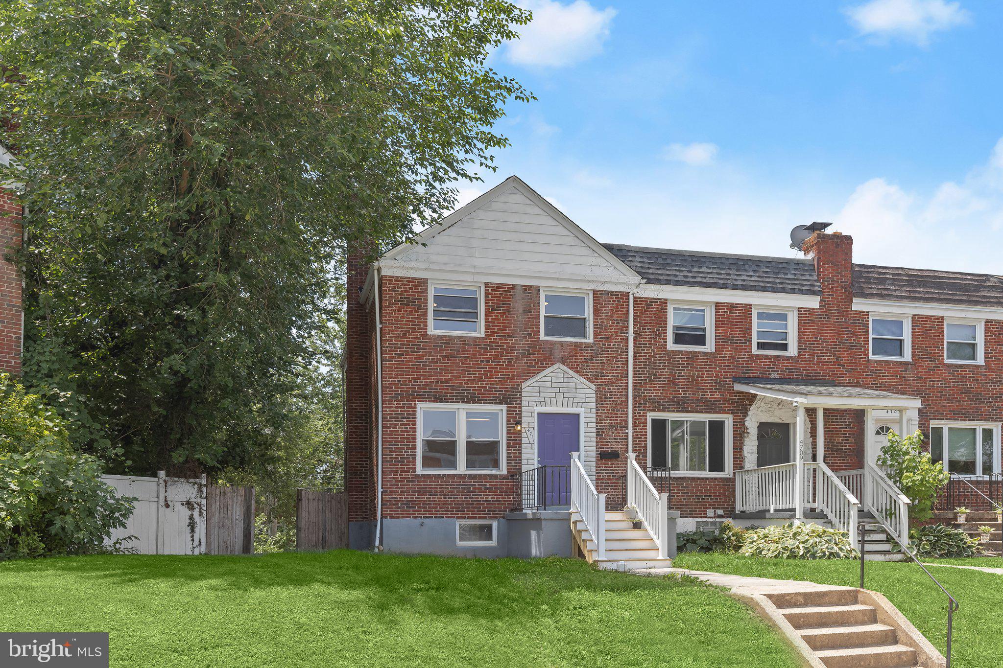 Welcome to this beautifully renovated end-of-group brick home offering four bedrooms and a move-in ready interior designed for today's lifestyle. Freshly painted throughout, the bright and airy main level welcomes you with a pleasing neutral color palette and wood-inspired luxury vinyl plank flooring that flows through the inviting living room and into the convenient main-level bedroom, ideal for guests, a home office, or flexible living.

The thoughtfully designed lower level serves as the heart of the home, where the spacious eat-in kitchen features coordinating appliances, including a gas range, and is enhanced by a custom tile backsplash that adds both style and functionality. With direct walkout access to the backyard, this level makes outdoor dining, grilling, and entertaining effortless. An adjacent room offers exceptional versatility as a formal dining room, sitting area, home office, or recreation space, creating a comfortable setting for everyday living and gatherings alike. A renovated powder room and utility room with laundry complete this highly functional level.

Upstairs, with fresh new carpeting, the private sleeping quarters include a spacious primary bedroom, two additional bedrooms, and a beautifully renovated full bath appointed with matte black fixtures and a tub-shower combination.

Outside, the fenced rear yard provides a wonderful space for pets, play, or gardening and is complemented by the convenience of a private parking pad. Blending modern updates, flexible living spaces, and practical amenities, this exceptional home is ready to welcome its next owner.
Note:  Select interior photos  have been virtually staged.