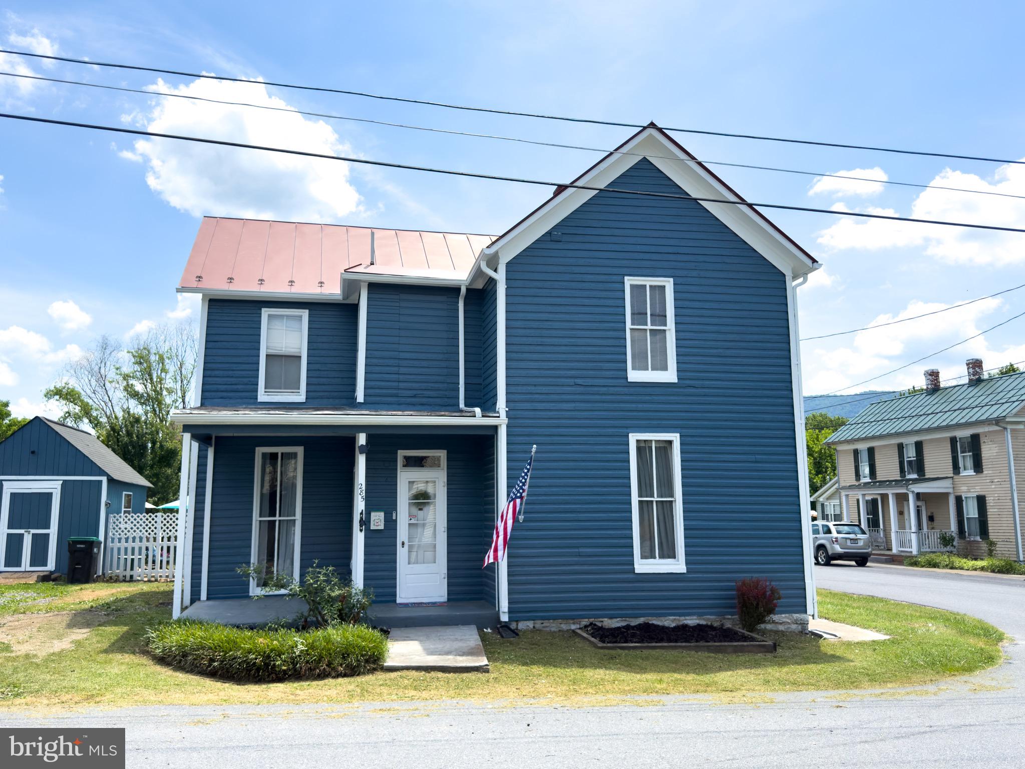 Professional photos coming 6/15! Welcome to 285 South Massanutten Street, a charming traditional farmhouse-style home offering 3 bedrooms, 1.5 baths, and a convenient location within walking distance to downtown Strasburg.

The exterior of the home has been freshly painted, giving it great curb appeal while maintaining its classic farmhouse character. Inside, the home features original hardwood floors that add warmth and charm. The layout offers comfortable living spaces, a formal dining room, and a large kitchen with lots of counter space. The full bathroom, located upstairs, has been fully remodeled.

Outdoor living is a major highlight, with a large backyard fully enclosed by a privacy fence, a patio area for relaxing or entertaining, and two storage sheds for extra space. The three-season back porch adds even more usable space and is perfect for morning coffee, gatherings, or simply enjoying the backyard setting.

With its farmhouse charm, freshly painted exterior, original hardwood floors, remodeled full bath, large private backyard, and walkable location near downtown Strasburg, this home offers a great blend of character, convenience, and everyday functionality.
