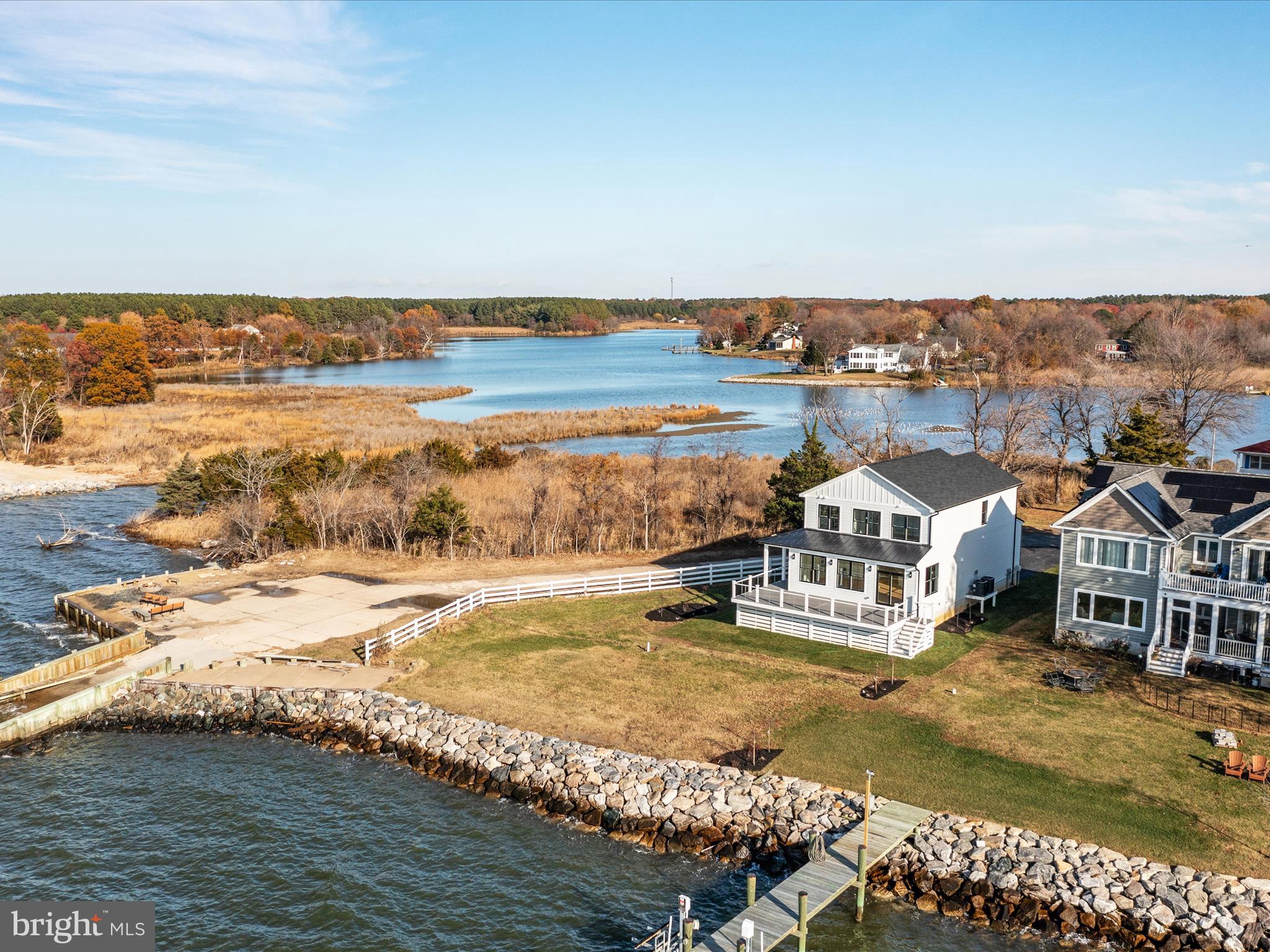 Gorgeous Chesapeake Bayfront Coastal Farmhouse!   Enjoy the most serene sunsets every night from your back deck or covered wrap-around porch.  Elevated homesite with new riprap along the water's edge.  This new home features hardiplank siding with stone veneer garage front, oversized garage door, wrap around composite porch/deck with stainless steel cable rails, and a low-maintenance exterior!  

Inside the home, modern farmhouse meets coastal living with beautiful finishes that make this home completely turn-key!  Gas fireplace in the family room with shiplap trim, solid wood floors, LED overhead lighting, Craftsman style trim and casing, a modern kitchen that opens to the main living space, custom steel railings, and the list just goes on and on.  The waterviews are so impressive, you'll feel like you're on a cruise ship!  The first floor also features a walk in pantry with custom built ins and powder room.

The second floor master suite will blow your mind with the incredible water views and sunsets!  Enjoy the water views even while you're in the shower!!!  Wood floors run through the upstairs hallway and into the two additional bedrooms, both featuring water views.  The full baths  feature tile floors as well as tile surrounds for an elevated feel.  Ceiling fans and designer lights are already installed!