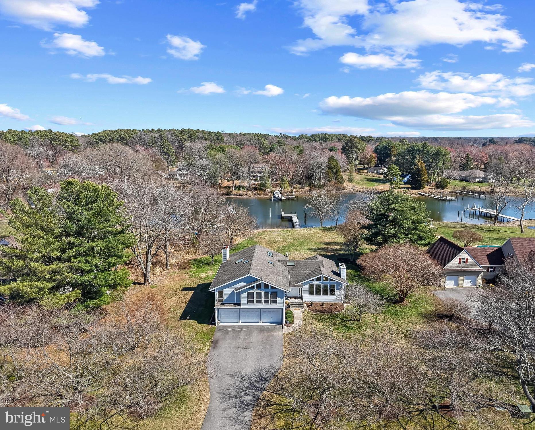 MAJOR PRICE IMPROVEMENT! Just in time to enjoy your Prospect Bay waterfront home this summer!

Welcome home to this waterfront property in the Eastern Shore’s premier golf course community of Prospect Bay. Set on just over an acre overlooking Little Greenwood Creek, this home offers peaceful views, spacious living areas, and direct water access. From the moment you enter, the welcoming foyer with coat closet opens to a bright living room with large windows plus a stone fireplace, and a dining area that overlooks the backyard and water, creating a light-filled space ideal for everyday living and entertaining.

The remodeled eat-in kitchen features abundant natural light, granite countertops, and direct access to the deck, where you can enjoy relaxing water views or dine outdoors. The home’s thoughtful layout continues on the lower level with an additional living area, half bathroom, laundry room, and convenient access to the spacious three-car garage. Sliding doors off the lower living area lead directly to the backyard and patio, seamlessly connecting indoor and outdoor living.

Upstairs, you’ll find four generously sized bedrooms, including a primary suite with beautiful water views, a walk-in closet, double vanity, and an electric fireplace that adds a cozy touch to the space.

Situated on a large lot, the backyard provides plenty of room for outdoor entertaining and offers the potential for a pool overlooking the water. The recently redone pier allows for easy access to Little Greenwood Creek and the Chesapeake Bay, making this an excellent opportunity for those who enjoy waterfront living and boat rides to the Narrows, Saint Michaels, Annapolis, and beyond.

Prospect Bay community offers an array of amenities, including an 18-hole golf course, a clubhouse with a members-only restaurant and bar, a marina with a launch, a pool, tennis and pickleball courts, a playground, and year-round social activities. Here, every day feels like a vacation.