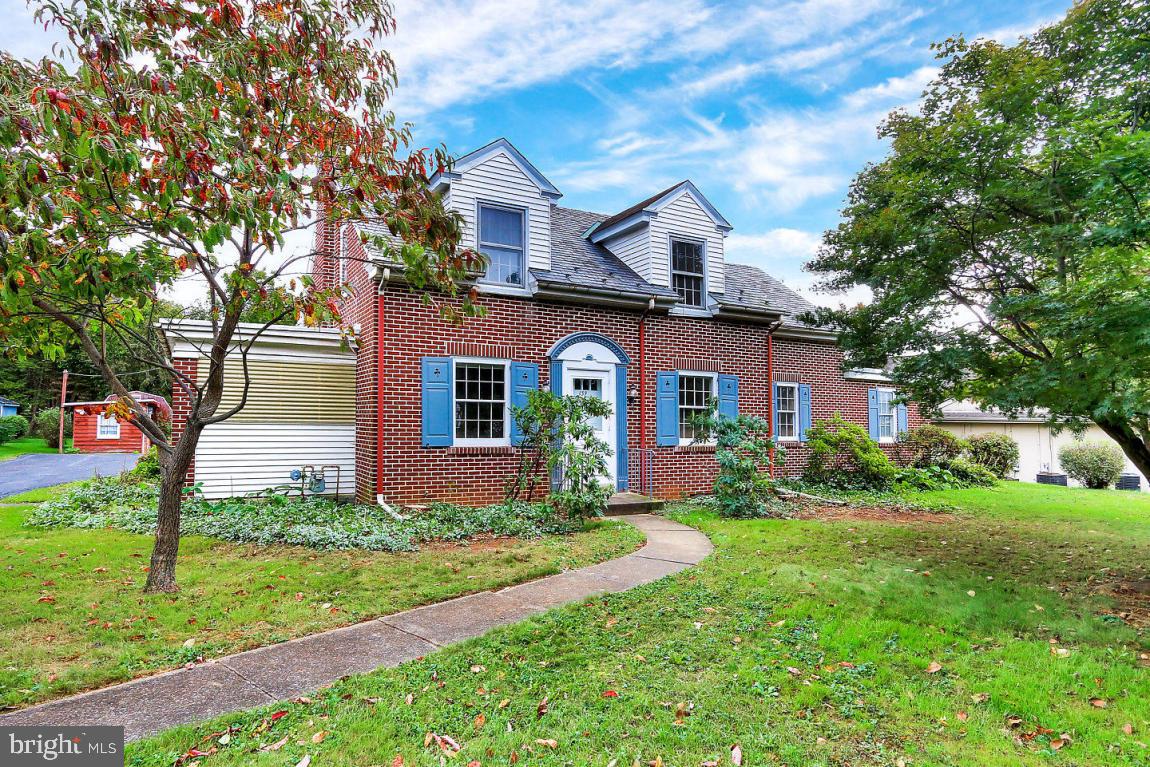 Solid 1940's brick Cape Cod with hardwood floors, wood burning fireplace, convenient location, plenty of off-street parking, level landscaped yard and large storage sheds.  Convenient first floor bedroom and bathroom and large sunroom.  Perfect for a private home, in-home business or commercial office space.  Property in good repair and sold as-is.