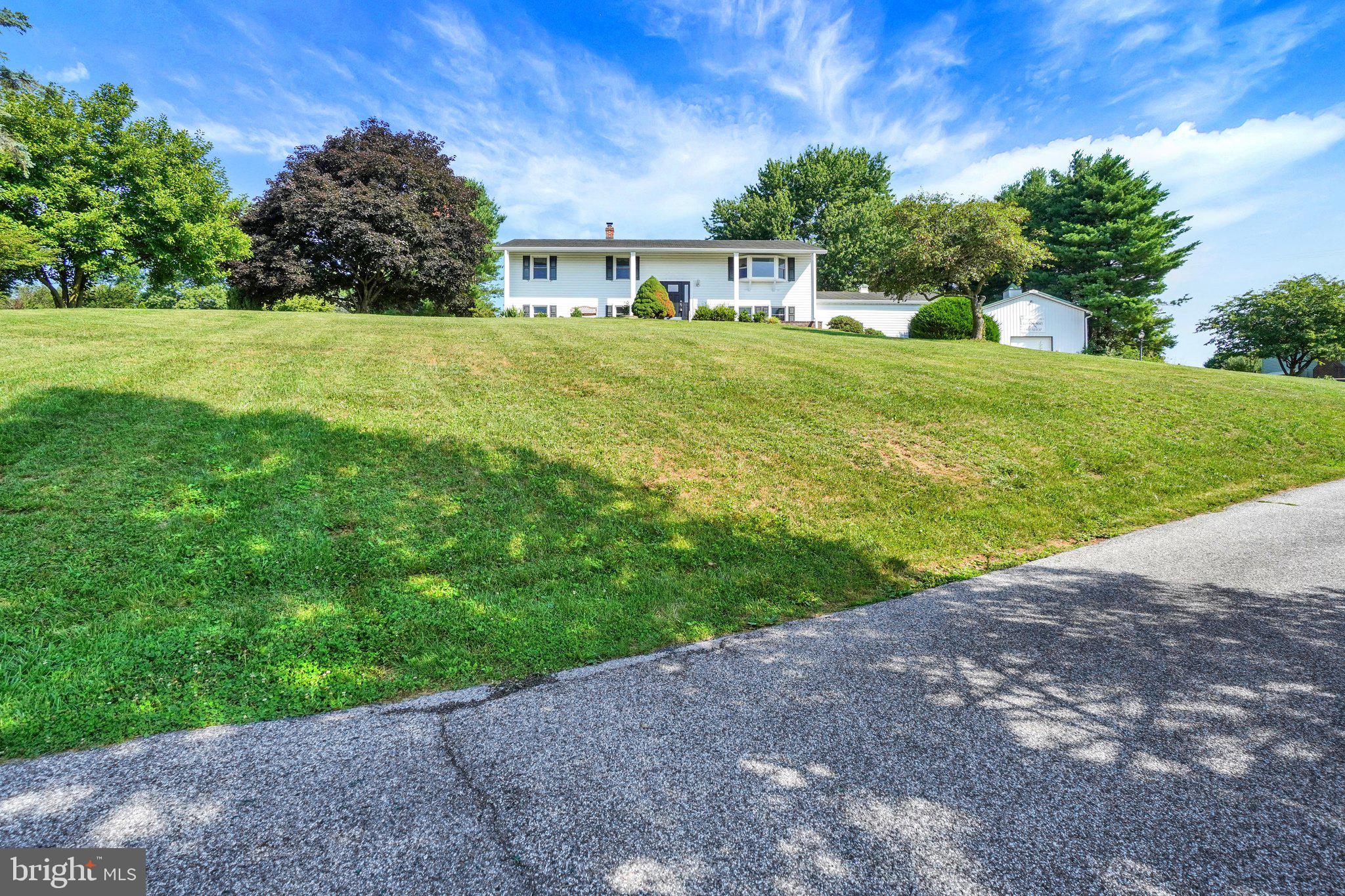 Large WORKSHOP + INGROUND POOL and modern updated home offering the perfect blend of comfort, functionality, and breathtaking countryside views! Enjoy panoramic views of the surrounding farmland from the inviting front porch, or unwind in the bright, vaulted sunroom overlooking the backyard oasis and in-ground pool.
Step inside to discover a spacious eat-in kitchen featuring modern finishes, perfect for casual meals and gatherings. The formal dining room provides the ideal setting for holiday dinners and entertaining. Luxury vinyl plank and tile flooring flow throughout the home, offering both style and durability. The beautifully renovated kitchen and updated bathrooms complement the home's modern appeal (both completed 2021). The thoughtfully designed lower level includes a kitchenette, living area, bedroom, office,  and laundry offers endless possibilities as a potential in-law suite, guest quarters, or private living space. The full basement provides abundant storage and additional potential to fit your needs. Recent improvements include new windows, a new hot water heater, new gutters, a new A/C condenser, and a new water softener system, providing peace of mind for years to come.
A true standout is the impressive garage/workshop, complete with a built-in air compressor, making it an ideal space for contractors, mechanics, car enthusiasts, hobbyists, or anyone needing exceptional workspace. Additional storage sheds provide convenient space for pool equipment, lawn equipment, and outdoor essentials.
Situated on 1.03 acres, the outdoor space is just as impressive. Spend your summers enjoying the in-ground pool, featuring a new liner, cover, and pump installed in 2021 (still under warranty), with a deep end reaching 8 feet. Whether you're entertaining on the spacious deck, relaxing in the sunroom, or simply taking in the peaceful country views, this property offers the perfect setting to enjoy every season.
This one-of-a-kind property combines beautifully updated living spaces, flexible multi-generational living potential, an incredible heated workshop, stunning rural views, and exceptional outdoor amenities—all in one remarkable property.