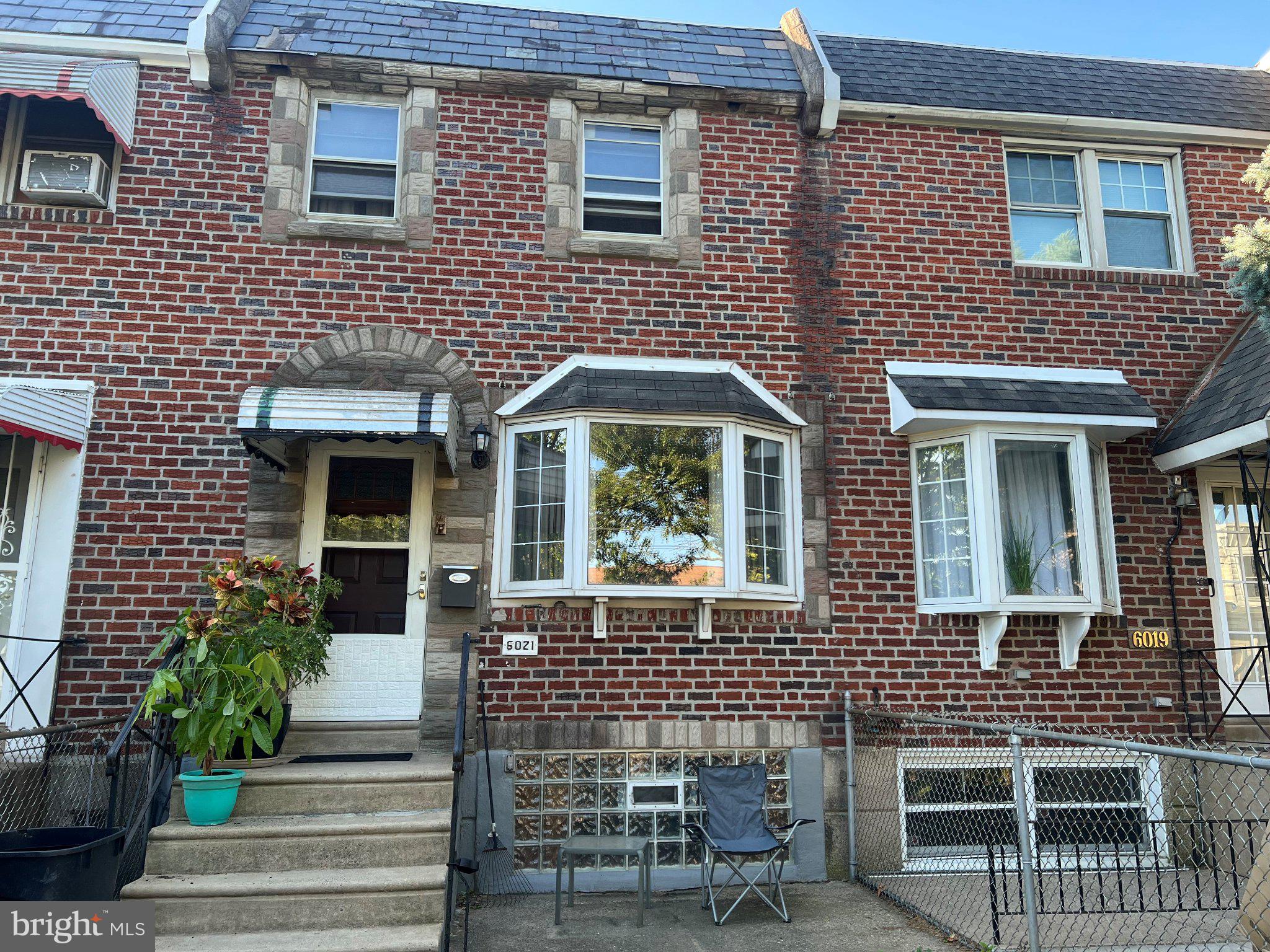 Welcome home to a 3 bedroom, 1-1/2 bath townhouse in the heart of Tacony. Enter into the living room, thru to the dining room area, then kitchen that leads to the finished basement with a powder room.  Upstairs is the main bedroom with double closets, shelves, ceiling fan and included is a flat screen TV with remote for a home retreat. There are two additional bedrooms and modern bathroom.  The finished basement provides a great family room, home office, or guest area with a powder room, several storage areas including a cedar closet and a separate laundry area with washer and dryer included. Safety feature of interior entrance to garage with remote door opener.   Major updates include a new HVAC system; skylight and roof and chimney liner to be installed. Ceiling fans are in the main bedroom, rear bedroom and living room.  Custom wooden blinds throughout.
Relax in the comfort of a central air home and you can also enjoy the summer breeze on the front patio. This home is conveniently located near shopping, dining and public transportation. This home is ready to make it your own.