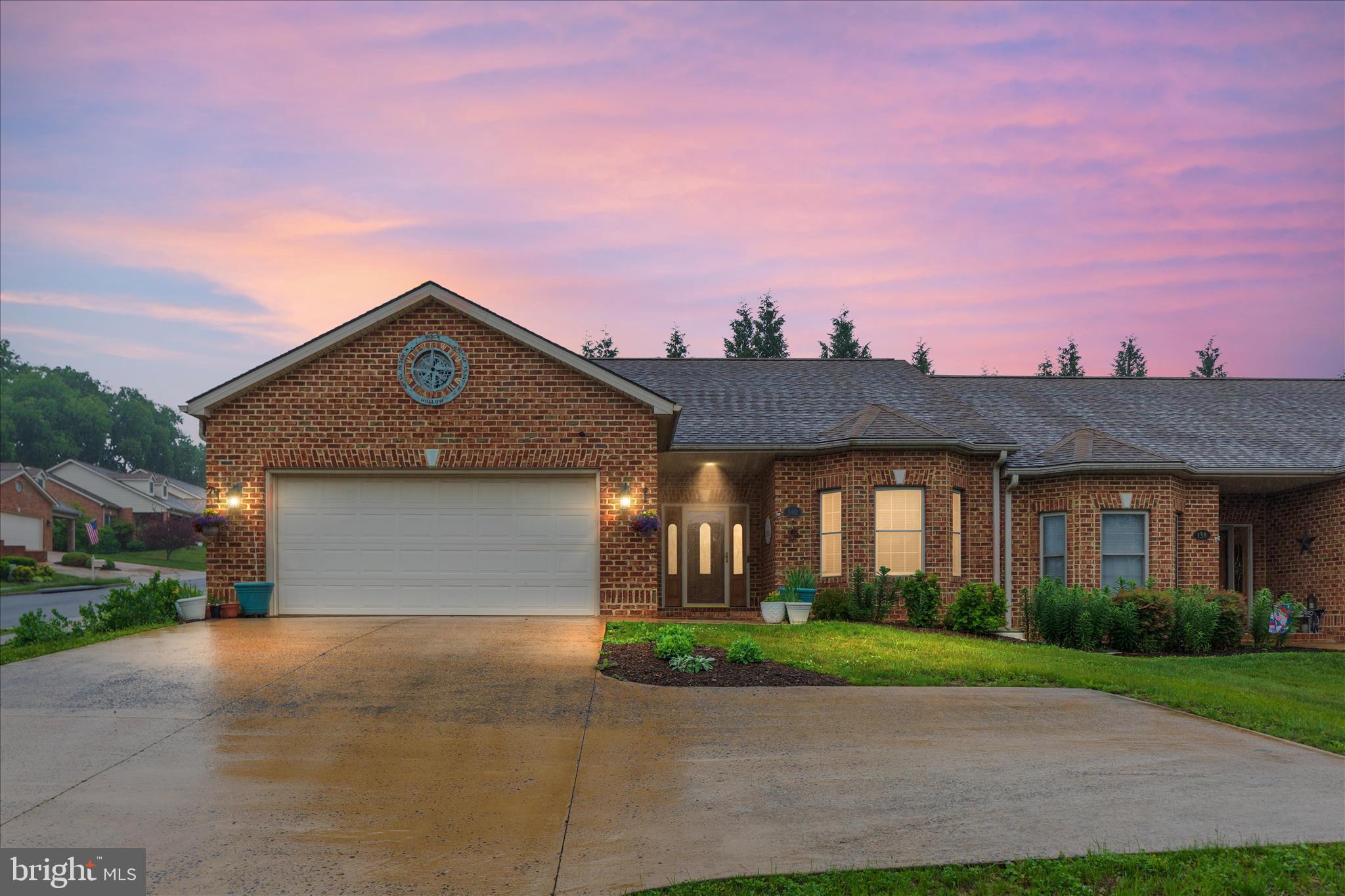 Great Location & Scenic vista mountain views! Beautiful 1629 Sq/Ft 2 bed, 2 full bath, 2 car attached garage duplex in Woodstock!  One level living at it's best in Camelot Estates! Corner lot with beautiful backyard & extensive professional native land scaping! Huge carpeted primary bedroom 20x12 with full bath & walk in closet! Propane fireplace with mantel in living room & crown molding with 9+ ceilings! Lots of closets & storage. Oversized concrete driveway for plenty of parking! Located in a very quiet neighborhood! Hardwood flooring in most of the house. Second extra large bedroom with bump out is carpeted with great mountain view from the front! Underground backyard electric fence for your little buddy. Permanent propane hookup on back patio for your gas grill! Close to everything! Shopping, downtown, restaurants, doctors, fairgrounds & HOSPITAL! All brick exterior construction and custom brick patio for entertaining friends and family! NO HOA!!! This home is very clean and shows well!! Agents bring your buyers, it won't last long!