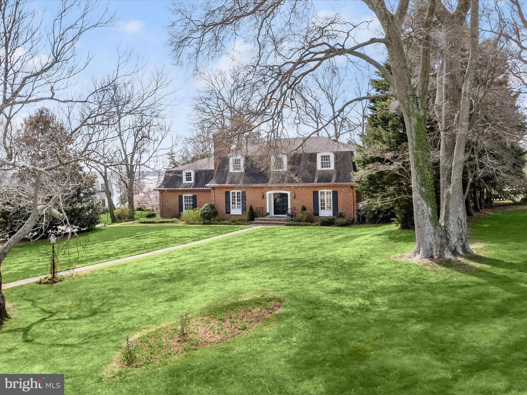Just in time for summer! A lovely brick waterfront cottage graciously sits on a beautifully landscaped, large corner lot on Otter Pond, Gibson Island ‘s 43-acre freshwater spring fed lake, offering sweeping views, inside and out, of the lake and the Chesapeake Bay.  With gleaming hardwood floors on the main and upper levels, this four bedroom, two and a half bath property offers an inviting table-size kitchen overlooking a cozy family room with wood burning fireplace. French doors in the kitchen open to the outdoor semicircular stone patio overlooking the lake and Chesapeake Bay. Park your car in the two-car garage and conveniently walk from the garage directly into the kitchen with your groceries. Entertain family and guests in the spacious dining room and good-sized living room with wood burning fireplace- both of these rooms also have French doors leading to the outdoor patio. A partially finished basement offers a rec room, laundry area and plenty of storage space. A large amount of storage space is above the garage and can be easily accessed upstairs.
Enjoy the wonderful water views as you barbecue on the built-in brick charcoal grill. Fish, swim, kayak, and canoe off the newly renovated, private dock. Separate steps lead directly to the water, providing delightful turtle watching and feeding of the ducks.  There is a grassy area perfect for picnicking outside and enjoying the lake and Chesapeake Bay views. On .62 -acre, this delightful property provides quiet enjoyment of active wildlife such as heron, basking turtles, ducks and osprey, and hundreds of birds.  Wildlife abounds!  
Put your feet up and relax, and enjoy life on magical Gibson Island! 
Information on Gibson Island:
Gibson Island is a private, secure island in the Chesapeake Bay within one hour of Washington, D.C. and Baltimore offering an absolutely extraordinary setting.  The Island comprises 1000 acres with seven miles of shoreline. Two thirds of the Island is undeveloped and is owned by the Gibson Island Corporation, the homeowners' association.  The remaining third is residential home sites. 
Gibson Island is located on the western shore of Maryland, so there is no need to cross the Bay Bridge. On the Island is a 43-acre spring fed freshwater lake in which one may enjoy non-motorized watercraft activities such as paddleboarding, canoeing, kayaking, fishing and swimming.  
The Island offers enormous privacy and security--there is an entry gatehouse staffed 24+Hours and the Island is patrolled by the Gibson Island Police Force (GIPD).  The Gibson Island Corporation Service Department offers yard maintenance and landscaping and other services for homeowners.  There is a full-service yacht yard.   From the Island, it is just a 20-minute drive to BWI Airport and the neighboring Amtrak train station.  
The Island houses a private country club (membership by invitation) offering yachting, fine dining year-round, tennis, an award-winning Charles Blair Macdonald designed 9-hole golf course, swimming, croquet, skeet shooting, and more.  (C)