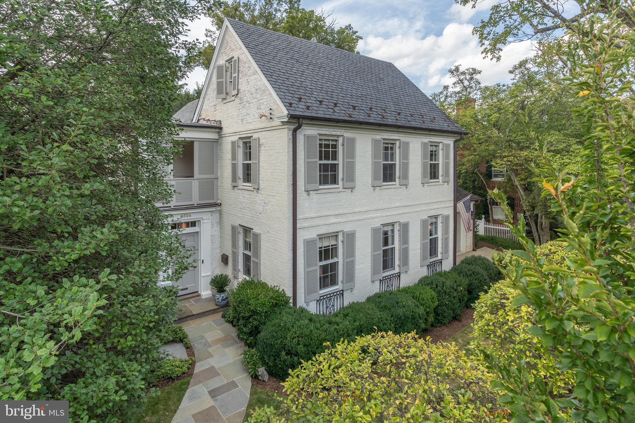 Ideally located in Colony Hill, a private enclave off of Foxhall Road, this exceptionally charming property has garnered admiration over the years and has recently undergone a remarkable transformation by the skilled craftsmen at Barnes & Zantzinger. Distinguished features of this home include covered porches on two levels, a gourmet kitchen addition, updated exercise room and a two-car garage.

The white-washed brick exterior, louvered doors, and inviting porches evoke a Charleston-inspired aesthetic. Boasting 5 BD/4.5BA  and nearly 4,500 square feet of stunning interior living space. Exterior features include a maintenance-free astro-turf lawn with mature landscaping, providing the yard ample privacy, and a putting green. Offers if any due Tues Sept 26th 10:00am.