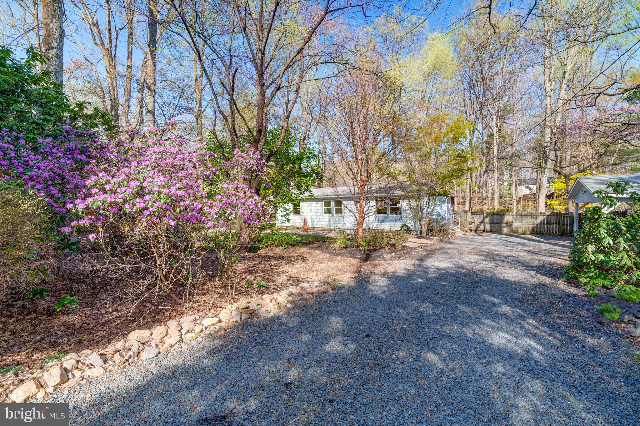 Extensively Upgraded and Truly Move-In Ready! Enjoy peace of mind with a brand-new roof (2025) and over $100,000 in thoughtful improvements throughout!!  Peaceful Retreat for Easy Living on Over an Acre!  Tucked away on a lush, tree-filled lot with vibrant flowering plants and a tranquil koi pond with a cascading waterfall, this inviting property is ideal for those seeking a simpler lifestyle surrounded by nature.   One-level living thoughtfully designed with an open layout,  this home offers comfortable space without excess. A spacious and bright sun room overlooks the serene backyard and pond—perfect for morning coffee or quiet reflection. This home has been tastefully updated with a series of thoughtful enhancements that elevate both comfort and convenience. Fresh interior paint, recessed lighting, and upgraded outlets lend a bright, modern feel throughout. The kitchen has been beautifully renovated (2024)  with new cabinetry, a central island, sleek quartz countertops, a new sink and faucet, and a recently replaced refrigerator. Durable luxury vinyl plank (LVP) flooring (2024) flows through the sunroom, bathroom, and main living areas.  The third bedroom has been opened to be used as an office, dining room, den or easily convert back to a bedroom.  The renovated bathroom features a custom walk-in shower and updated vanity. Climate comfort is ensured with a mini split heat pump system, replacing the original baseboard heating. Outdoors, the koi pond is enhanced by a new stone surround and Aqua Ultraviolet Viper pump system. A brand new well pump (2025) brings peace of mind for years to come.  A newer (2023) water pressure tank supports the water heater, and a fully wired carport was recently added (2022), providing both covered parking and increased functionality. Nestled in a park-like setting, this beautifully updated home offers exceptional privacy on a serene one-acre lot.  Enjoy the relaxed, tranquil ambiance of sitting by the koi pond, surrounded by nature. The property is located in an established neighborhood with convenient proximity to local amenities, while nearby attractions such as Silver Lake Park, James S. Long Regional Park, The Winery at La Grange, and The Farm Brewery at Broad Run offer endless opportunities for outdoor enjoyment and leisure. With close access to I-66, commuting and exploring the region is effortless.