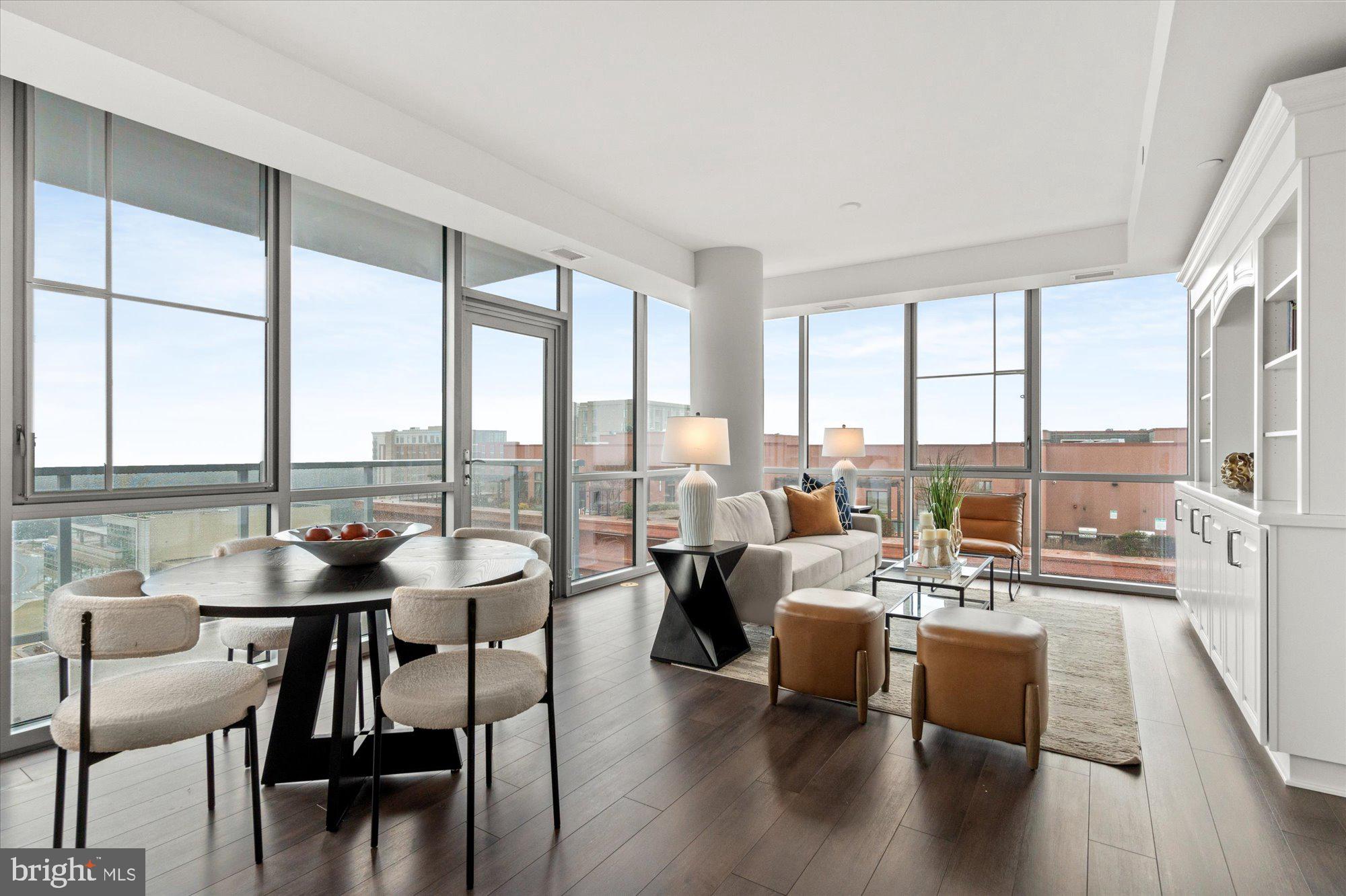 $699,000 — Luxury corner-unit condo in Pike & Rose, one of North Bethesda’s premier walkable urban communities. Exceptional opportunity to own a move-in-ready condo just steps from the Red Line Metro, top-rated restaurants, boutique shopping, entertainment, and major commuter routes.  This sun-filled 2-bedroom, 2-bath condo features floor-to-ceiling windows, open-concept living, skyline and sunset views, and a private balcony. The modern Euro-style kitchen offers a quartz waterfall island, sleek cabinetry, and stainless steel appliances designed for today’s luxury lifestyle.  Enjoy resort-style amenities including concierge service, fitness center, rooftop lounge, outdoor grilling terrace, garage parking, additional storage, and pet-friendly living.  Ideally located near Bethesda, Rockville, Washington, DC, I-270, and I-495, this luxury North Bethesda condo offers the perfect blend of convenience, style, and low-maintenance living in a high-demand location.  Vacant and move-in ready. Photos reflect staging furniture.