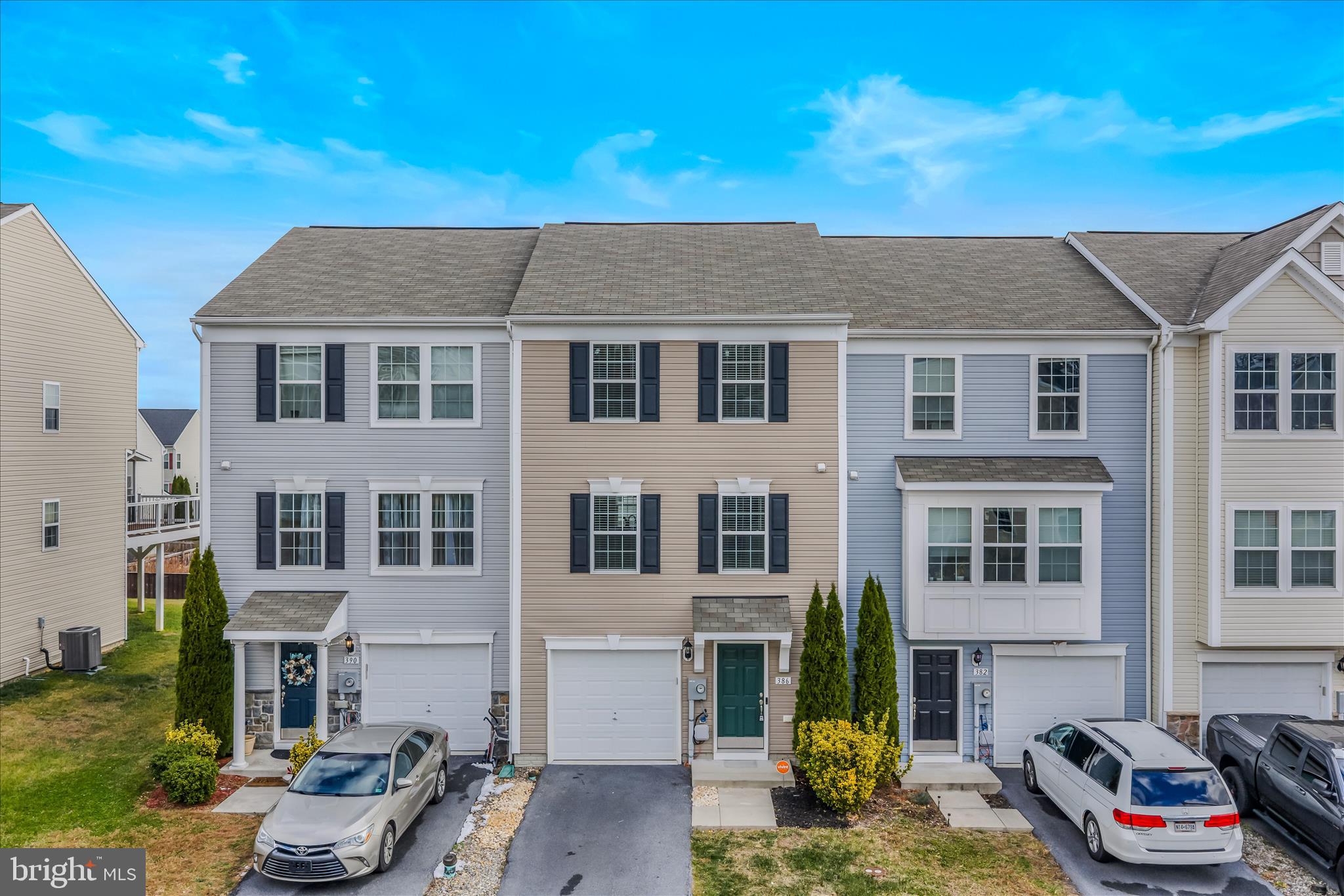 Welcome to 386 Rumbling Rock Road in Hedgesville, WV—a wonderfully refreshed three-level townhouse that blends comfort, style, and convenience. Inside, you’ll find new flooring, fresh paint, and a bright, inviting atmosphere that makes this home feel truly move-in ready. The main level offers a warm and functional layout perfect for everyday living, featuring a spacious kitchen with ample counter space, an island, and stainless steel appliances—ideal for cooking, entertaining, or meal prepping. The adjoining living room provides a comfortable, light-filled space ideal for relaxing, hosting friends, or enjoying quiet evenings at home. A convenient half bath completes the main level. Upstairs, you'll find a spacious primary suite with a vaulted ceiling, walk-in closet, and private ensuite bath. Two additional bedrooms and a full hall bath round out the upper level. The finished lower level provides even more flexibility—ideal for a cozy rec room, home office, gym, or play space—and includes a rough-in for an additional half bath, giving you the option to expand and customize to your needs. Whether you're searching for your next home or a fantastic investment opportunity, this property checks all the boxes. Updated, low-maintenance, and perfectly located near shopping, dining, schools, and commuter routes—this townhouse delivers easy, comfortable living at its best. Schedule your tour today!