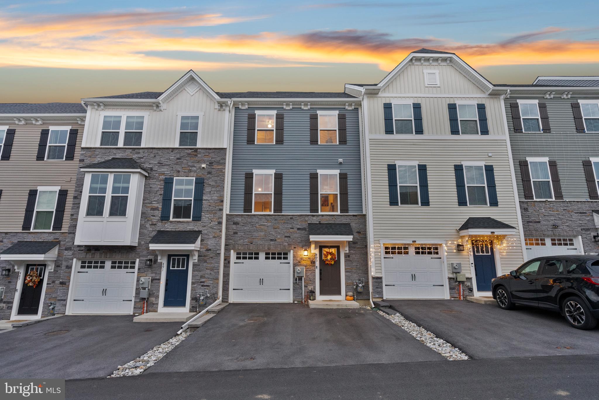 Looking for new construction and don't want to wait! Look no further and book a showing at this beautiful 2 year old Strauss model which is the biggest model they have in the neighborhood. This model offers 2,285 sq ft of finished living space and has all the extra options you can add, plus more added by the owner! Don't forget this is in the award winning Downingtown School District and STEM academy, while being close to the Downingtown borough and much more. When walking in the front door, the foyer leads you in the ample sized family room that the owner converted into a 4th bedroom adding a beautiful farmhouse style sliding door to the entrance. That room has a siding door that leads out to the backyard. The one car garage is also on this level. Walking up the stairs you enter the main level. This level has the gorgeous open floorplan, quartz countertops, upgraded LVP, upgraded lighting, custom fireplace, custom pantry with butcher block, upgraded half bath vanity/mirror and Levolor blinds. The ample sized family room and kitchen made the house seem very charming. The dining room area can house a large table and plenty of room for party dinner and activities. The siding door opens to the exterior deck that is a great added space for outdoor fun and dinners.  There is a beautiful half bath on this level as well. Moving upstairs, This level offers the upgraded LG washer and dryer. The three bedrooms on this level are large with great closet space. The hallway bathroom is bright and has a tiled tub. The master bedroom is unbelievable with its vaulted ceilings, huge walk in closet and custom fan. The master bathroom has a walk in shower and large soaking tub. Don’t miss this house, Book your showing today!