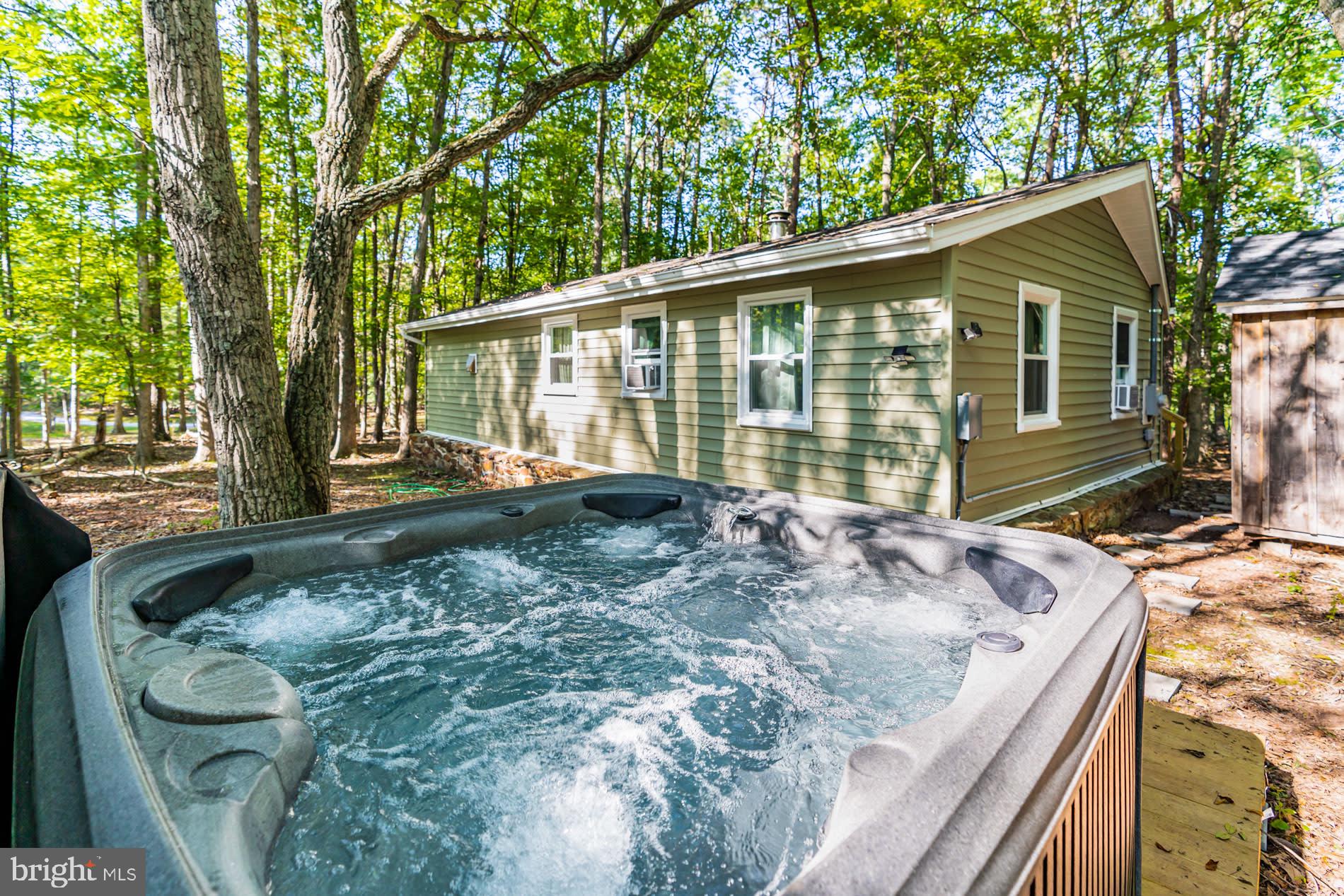 Charming 3-bedroom, 1-bath cabin in Sleepy Creek featuring bright living spaces with vinyl plank flooring and a cozy wood stove.  This house was completely renovated four years ago – including a new roof, vinyl siding, large front deck, heat pump, bathroom, kitchen with all stainless steel appliances, water heater, 200 amp electric service and more. Outdoor amenities include a new deck, hot tub, and fire pit. As a vacation rental it has generated $133,000 over the past 3 years ($37,000 in the past year alone!), and can come with an existing property manager and cleaner.  This cabin is located in Sleepy Creek Farms, with private access to a large community pond stocked with fish (and with several picnic tables nearby), just a quick 5 minute walk from the cabin. Hot tub and furniture optional, available for purchase.  See seller docs for a summary of rental history and financials. $1,000 buyer credit if you continue using the same property manager.  Perfect vacation home or investment property!