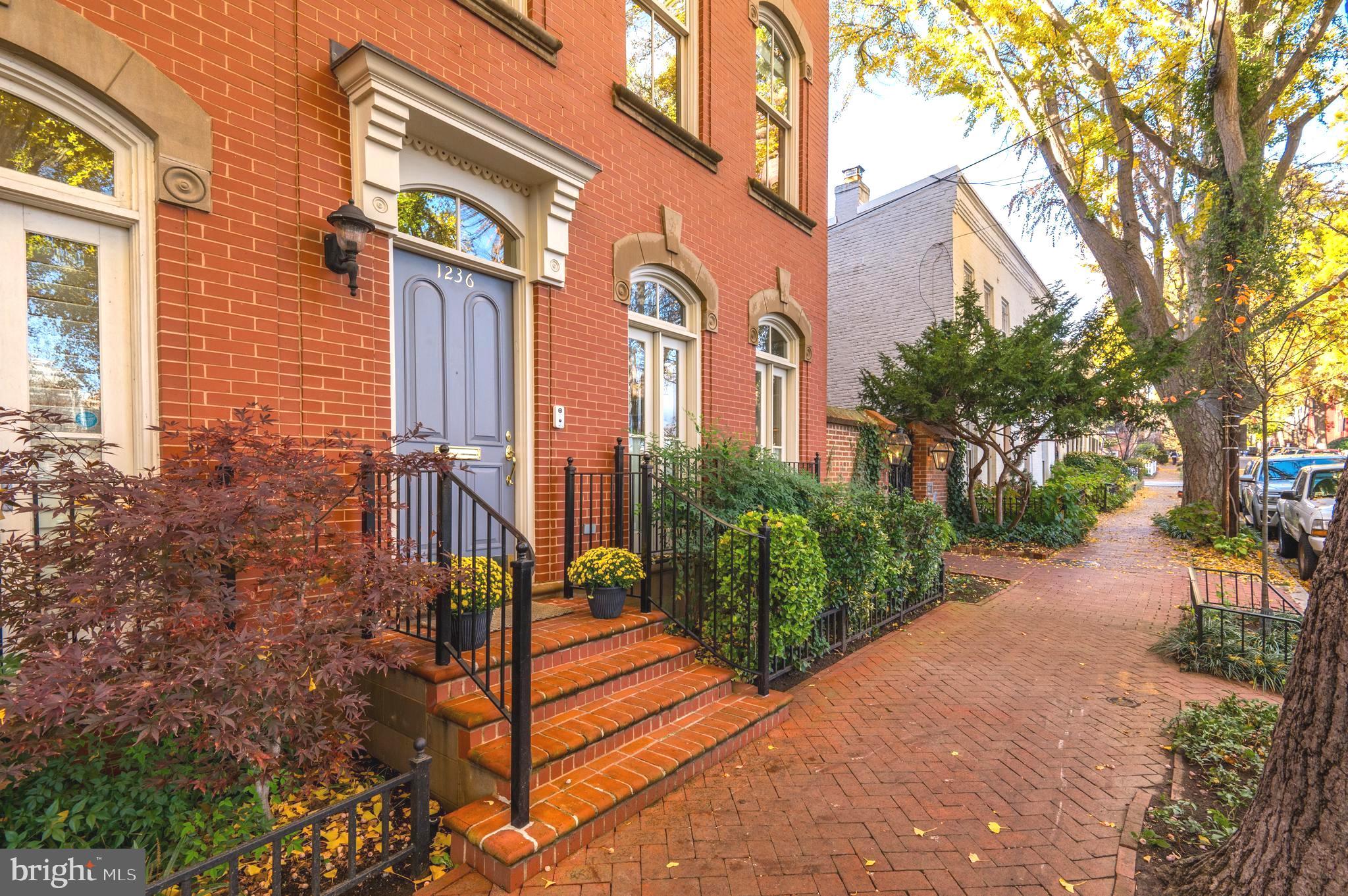 Nestled amidst the serene charm of Georgetown’s East Village and directly across from Rose Park, this immaculate semi-detached Phillips Row town home harmoniously marries modern comforts with the timeless allure of historic Georgetown. Built in 2000, this residence stands as a testament to refined craftsmanship in an unrivaled world class location.
  This residence possesses a beautiful aesthetic that offers timeless sophistication and elegance. Ornamented with stone details and exquisite millwork, the front façade sets an elegant tone. Inside, an abundance of natural light dances through the home's three-sided exposure, accentuated by numerous windows and lofty ceilings that infuse each space with a sense of openness. 
  Upon entry, a gracious foyer leads seamlessly to a renovated eat-in kitchen boasting top-tier stainless-steel appliances and an adjacent breakfast area flanked by French doors that open onto Juliet balconies which overlook Rose Park with unobstructed views. Flowing effortlessly from the kitchen is a dining room and a generously-proportioned living area clad with contemporary wood paneling, a gas fireplace with marble surround, and a wall of windows with glass-paneled doors inviting you to the private rear terrace.
  Ascending to the second level reveals a luxurious primary suite boasting four oversized windows facing East and North, built-in desks, a walk-in dressing room, and a renovated en-suite bathroom exuding sophistication with dual vanities, a frameless glass shower, and a jacuzzi tub. There is an additional light-filled guest suite with a bedroom offering ample built-ins and two double door closets and a full bathroom on the second floor
  The third floor boasts two more bedrooms, one featuring a private balcony, and a beautifully appointed hall bathroom complete with dual vanities. The lower level is an expansive space featuring a large family room with built-in bookshelves, an additional bedroom, full bathroom, ample storage, and a laundry room equipped with shelving and utility sinks.
  Stepping outside, discover a spacious and private flagstone terrace cocooned by a brick privacy wall, accented with lush flower beds and meticulously landscaped gardens—a serene setting perfect for entertaining. For added convenience, a secured parking space rests just off the terrace at the rear.
  1236 27th Street NW stands as a paragon of modern city living, epitomizing the fusion of craftsmanship, practicality, and an unparalleled Georgetown locale—one of the most distinguished offerings within the Capital Region's real estate landscape.