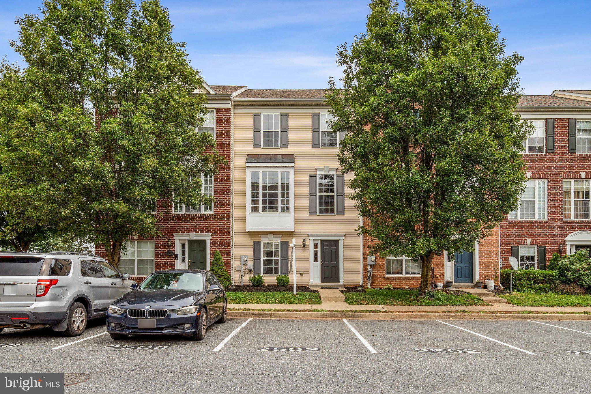 Welcome to this beautifully updated three-level townhome in Whittier, one of Frederick's most premier and sought-after communities! Whittier residents enjoy multiple outdoor pools, ample walking paths and a park for recreation. There is also a community BBQ restaurant, pizza place, hair salon and liquor store, all walking distance to the property. From the moment you enter, the brand new Luxury Vinyl Plan(LVP) flooring and freshly painted interior create a bright, move-in ready feel throughout. The entry level offers a versatile bonus living space or rec room, a full bedroom with a private ensuite bath, a laundry room, and a walk-out to the backyard. The rec room area is exceptionally unique as the ceiling height in the rear of the basement is 10+ feet, creating an unparalleled feel.  It could be a perfect home theatre or golf simulator room! The main level impresses with an open, airy layout featuring new LVP flooring from front to rear, an eat-in kitchen with updated quartz countertops and brand new stainless steel stove and refrigerator, and easy access to the rear deck, ideal for morning coffee or evening entertaining. Upstairs features three generously sized bedrooms and two full  baths, providing comfort and space for the whole household. The primary suite has a vaulted ceiling, walk-in closet, en-suite bath and rear view. The two additional bedrooms are supported by a hall bath.  Two assigned parking spots right in front of the home. The Whittier community elevates everyday living with an outdoor pool, tot lots, a scenic pond, and local dining all just steps away, with unbeatable access to Rt. 15, I-270, and I-70 for an effortless commute in any direction  and Downtown Frederick and Fort Detrick just minutes from your front door. This one checks every box, don't miss it!