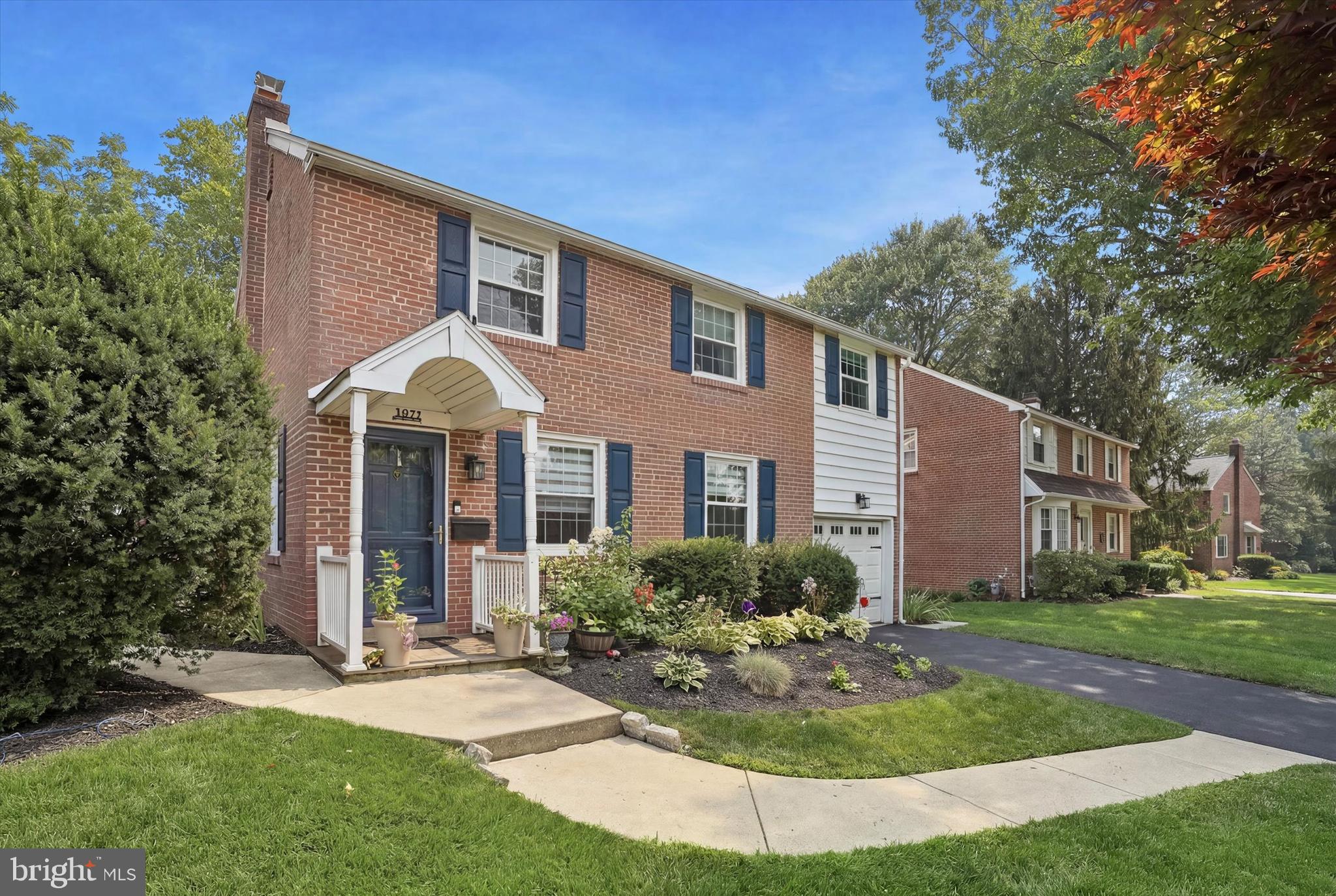 Welcome to this beautifully updated red brick two-story home in the desirable Whitemarsh Hills community, located in the highly regarded Colonial School District. This charming home offers 3 bedrooms, 1.5 baths, an attached garage, and a finished lower level.

The updated and expanded kitchen area with a view to the back yard - features granite countertops, stainless steel appliances, abundant cabinetry, and an oversized granite island with breakfast bar seating. The kitchen opens to the dining area, creating a wonderful open-concept space ideal for everyday living and entertaining. Convenient main-floor laundry and a powder room add to the home's functionality. Tile floors with a hardwood look, abundant natural light, and pride of ownership are evident throughout. Bedroom 2 with oversized closet. Central air.

The finished lower level provides exceptional additional living space with recessed lighting, built-ins, abundant storage. Step outside to an amazing, fully fenced backyard featuring mature landscaping, a covered flagstone patio with ceiling fan, plus an additional backyard patio—perfect for entertaining, relaxing, or enjoying the outdoors.

Tucked away in a quiet neighborhood, yet just minutes from the Pennsylvania Turnpike and I-476, this home offers easy access to Chestnut Hill, Conshohocken, and Ambler. A wonderful combination of thoughtful updates, exceptional outdoor living, and an unbeatable location.