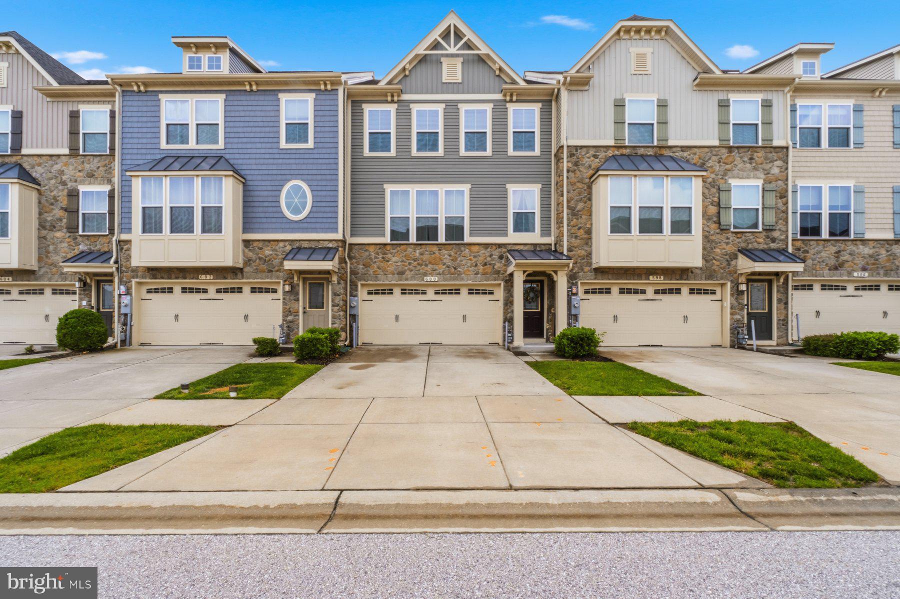Over $10,000 price improvement!!! Great opportunity to own this upgraded 3-level townhouse in a premium location within the community! Walk right out of your private fenced rear yard to the fabulous community pool and clubhouse, plus enjoy additional nearby parking perfect for guests and entertaining. This move-in ready home features 3 bedrooms, 2 full baths, and 2 half baths and has been lovingly maintained by the original owners. 
Boasting 9-foot ceilings on all levels, the spacious kitchen is complete with white 42" cabinets with crown molding, granite countertops, stainless steel appliances, recessed lighting, pantry, and a convenient half bath. The open dining area flows seamlessly to the composite deck backing to trees, while the grand living room offers plenty of space and a ceiling fan for comfort. The main level also showcases beautiful 5" scraped engineered hardwood flooring throughout and upgraded hardwood stairs with elegant iron and wood railings. The spacious primary suite features a ceiling fan, walk-in closet, and a luxurious super bath with ceramic walk-in shower, soaking tub, and double vanities. The bedroom level also includes a convenient laundry area, two additional bedrooms, and a full hall bath. The lower level offers a finished family room/recreation/gaming or gym space featuring an additional half bath, drywalled 2-car garage, and walk-out access to the privacy fenced yard with shed. Move right in and enjoy this exceptional home and location!  ***Open House Sunday 5/31/26 11:00AM-1:00PM***