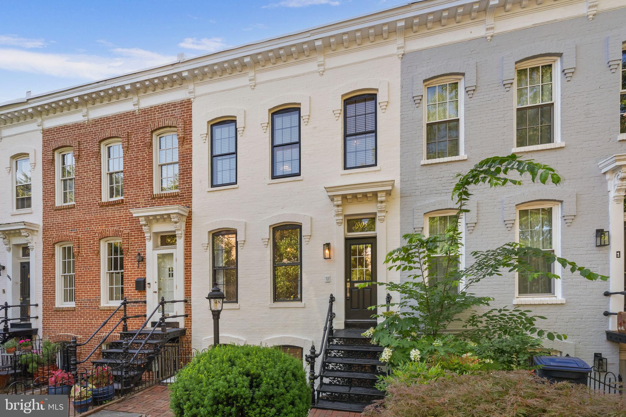 Ideally located moments from 14th Street in the heart of Dupont Circle, this beautifully renovated townhome seamlessly blends historic character with sophisticated modern updates. Offering three spacious bedrooms, multiple outdoor living spaces, and thoughtfully curated finishes throughout, this residence delivers an exceptional urban lifestyle in one of Washington's most sought-after neighborhoods.

The sun-filled main level features soaring 13-foot ceilings, original marble fireplaces, custom millwork, and newly refinished hardwood floors. An open-concept layout creates an inviting flow for both everyday living and entertaining, while a stylishly updated full bath adds convenience and functionality.

The English basement level showcases exposed brick, elegant wainscoting, and a well-appointed kitchen featuring all-new stainless steel appliances, including a refrigerator, stove, and microwave. Additional major system upgrades include a brand-new washer and dryer, HVAC system, furnace, and water heater, providing modern comfort and peace of mind for years to come.

Upstairs, two generously sized king bedrooms and a dedicated home office provide flexibility for today's lifestyle. The renovated upper-level bathroom features contemporary finishes and timeless design.

Outdoor spaces are equally impressive, highlighted by a brand-new Trex deck, a private backyard retreat, and a charming front patio—perfect for relaxing, dining, or entertaining guests.

The location is unmatched. Just moments from Dupont Circle and U Street Metro stations, residents enjoy effortless access to Whole Foods, VIDA Fitness, Starbucks, Meridian Hill Park, and some of the city's most acclaimed restaurants, including Le Diplomate. The home will also benefit from the upcoming Dupont Circle pedestrian promenade project, which is set to enhance the neighborhood's walkability, public spaces, and vibrant streetscape.

Combining historic elegance, extensive upgrades, modern comfort, and an unbeatable location, this move-in-ready Dupont Circle townhome presents a rare opportunity to own a truly exceptional Washington residence.