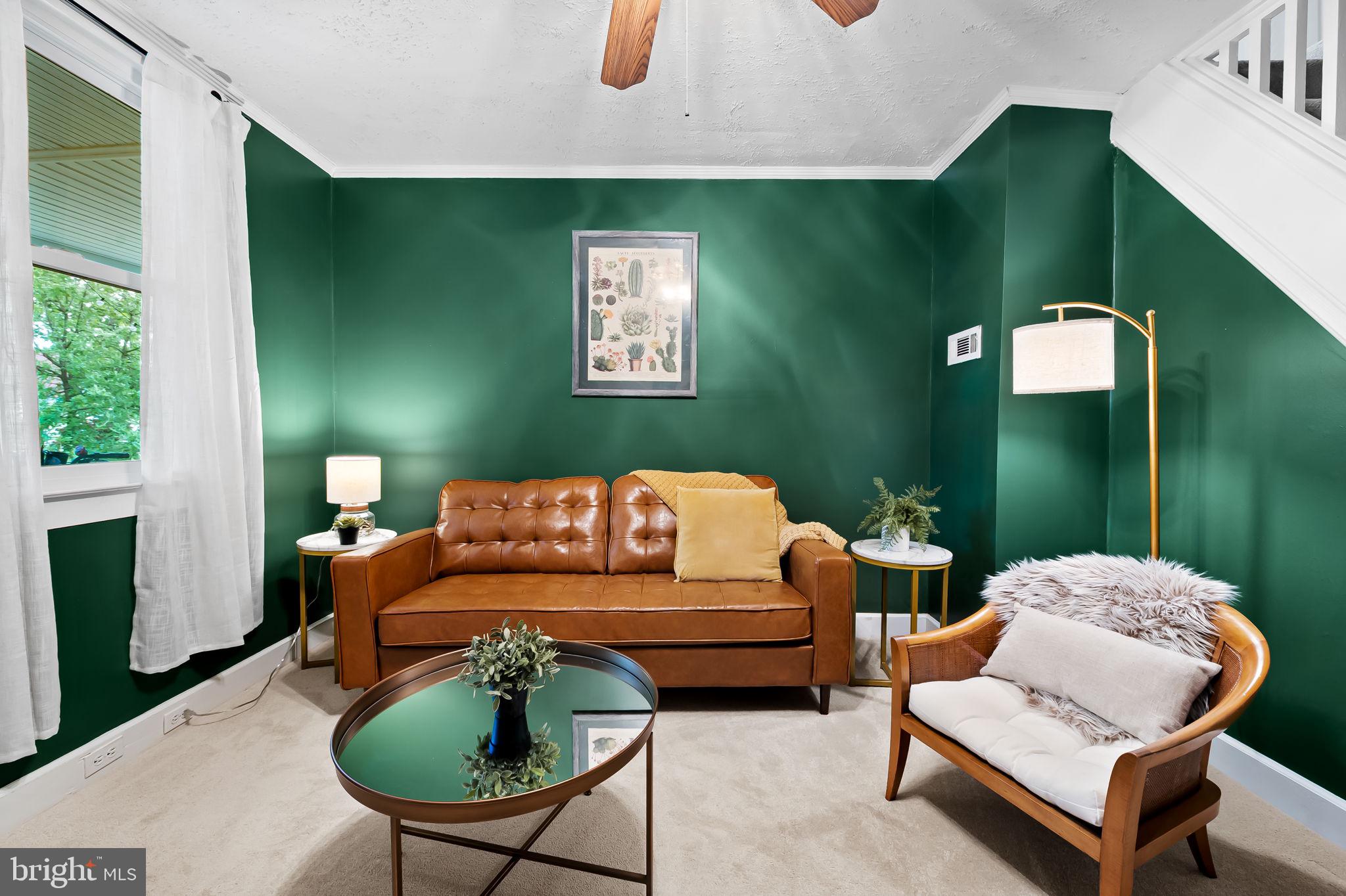 Nestled in the heart of Hampden, this beautifully updated three-story brick rowhome combines historic Baltimore charm with stylish, modern updates.  Enjoy peace of mind with brand-new updates throughout, including new windows, a new furnace, new water heater, new roof, and a brand-new front porch—all the big-ticket items are already taken care of.
Just steps from “The Avenue” and everything that makes this neighborhood one of the city’s most beloved, 3432 Roland offers a rare opportunity to enjoy walkable city living at its best.Step inside to find Open concept spacious living room as it  flows seamlessly into the kitchen, featuring new appliances including a brand new stove , and ample storage.  Cold storage rear porch functions as a pantry and mudroom helping you stay organized. Upstairs, you’ll find comfortable bedroom, closet/ dressing room or extra office space  and a full bath. The finished lower level offers flexible space for a guest room, home office, or media area, along with convenient laundry, storage, and a full bath. A ground level entrance and large windows make this feel more like main level living space than a basement and would be great short term rental opportunity. Outside, enjoy a welcoming extra large front porch, and small outdoor space in front and back. Just enough for a few plants to enjoy but not large enough to require a green thumb. Located minutes from boutique shopping, award-winning dining, and local parks, this Hampden gem offers the true charm of Baltimore living — where historic character meets vibrant community.