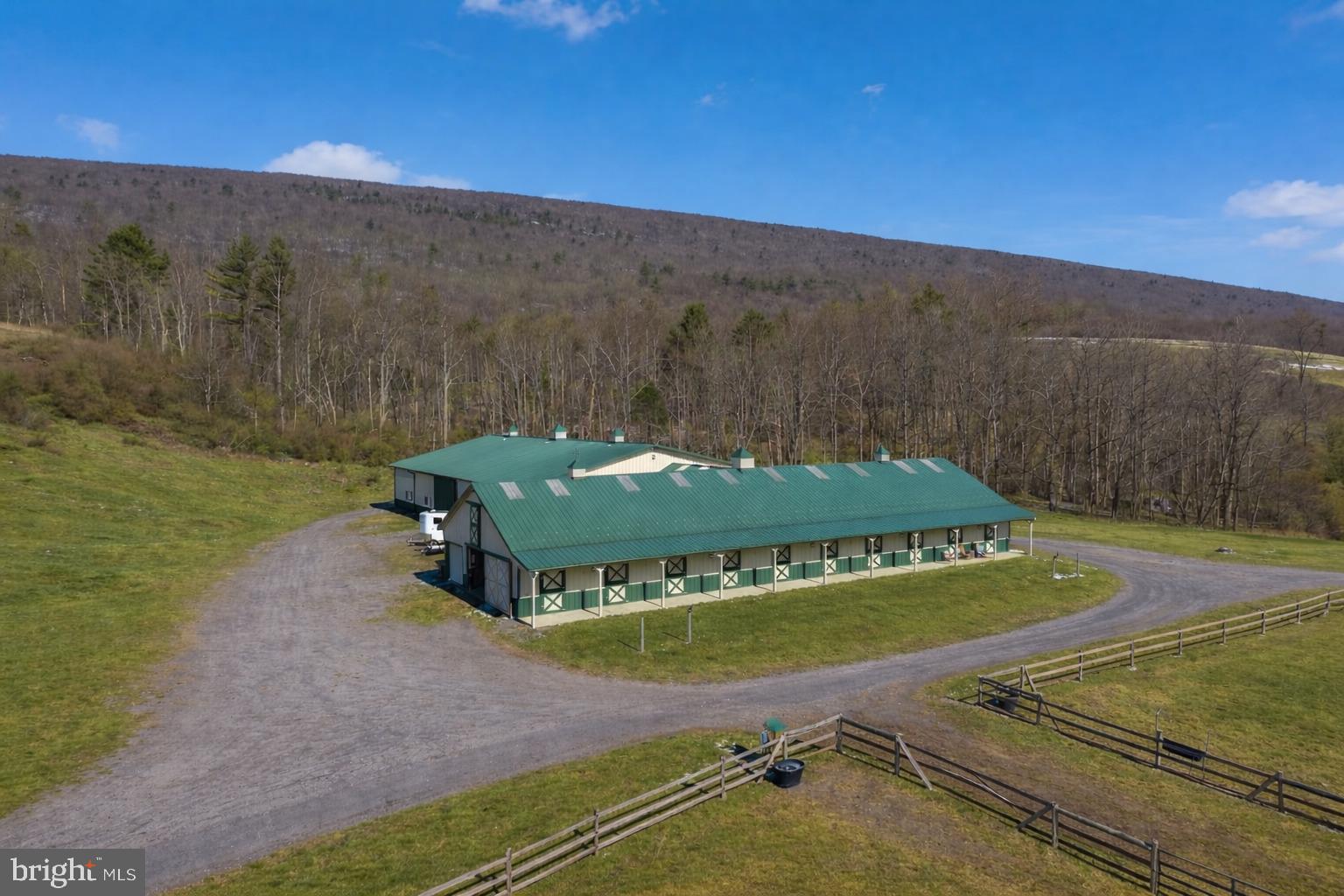 Rare 204-acre equestrian estate featuring a modern 12-stall horse barn with wash bay, tack room, feed room, and upper-level hay storage, along with 39 acres of pasture divided into six paddock. Training facilities feature an 80'×120' indoor riding arena and a large outdoor arena. The land offers approximately 58 acres of tillable ground and 133 acres of woodland, creating an excellent mix of agricultural use and recreation. Ideal for a private equestrian estate, training or breeding operation, or agricultural investment.
