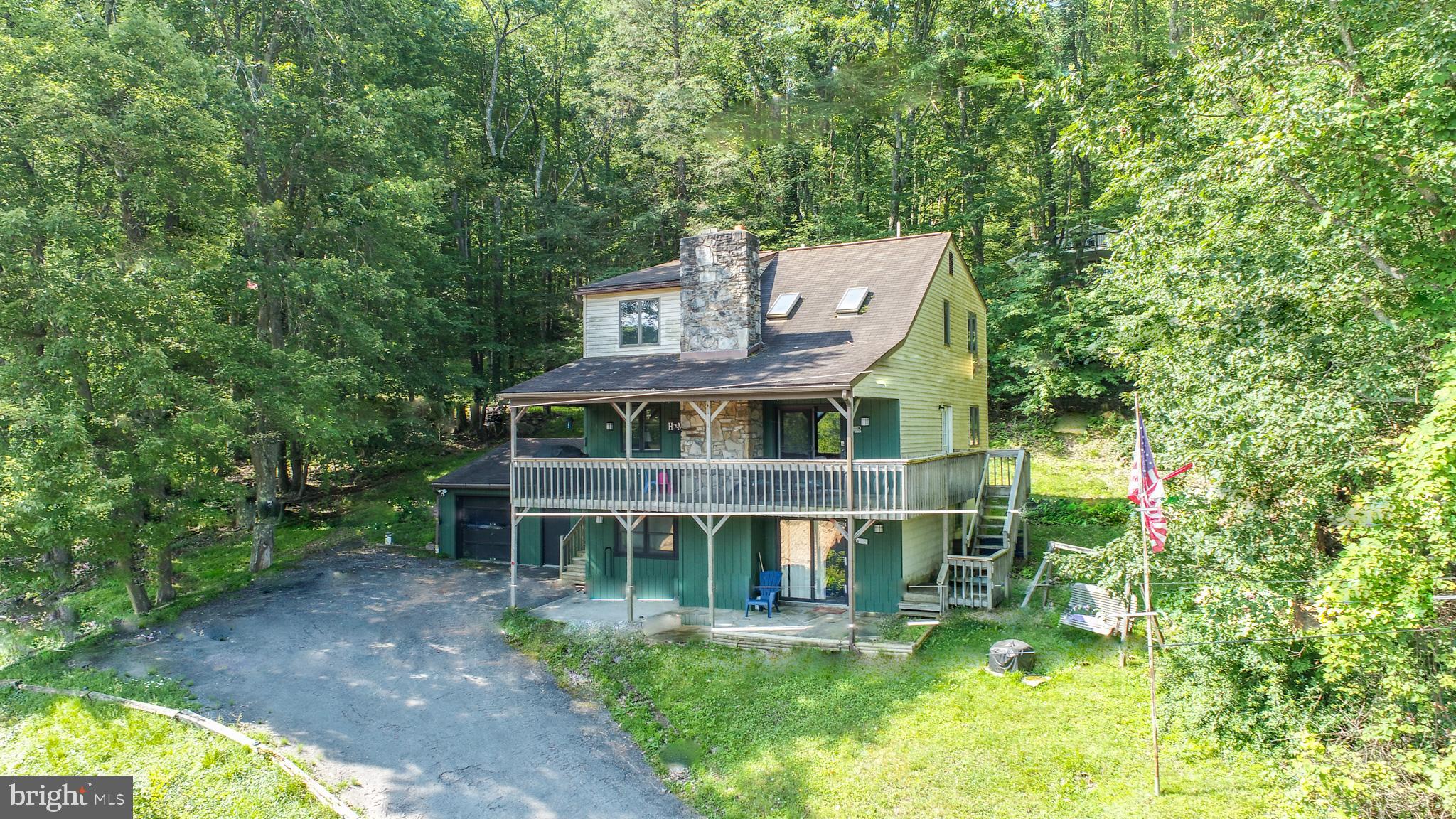 Perched above the treetops with panoramic lake views, this three-level retreat blends comfort with clean, considered upgrades. Vaulted ceilings and a spacious loft crown 2,235 square feet of living space, wrapped in new flooring with fresh paint inside and out. The kitchen, smartly updated with new countertops, connects to open dining and living anchored by a wood stove. A detached garage sits off the drive; while the private deck draws the eye to the water. An established rental, “Views and Brews” is being sold fully furnished and ready to go. Just minutes to marinas, Wisp Resort, and the lake’s best bites. Call today for details!