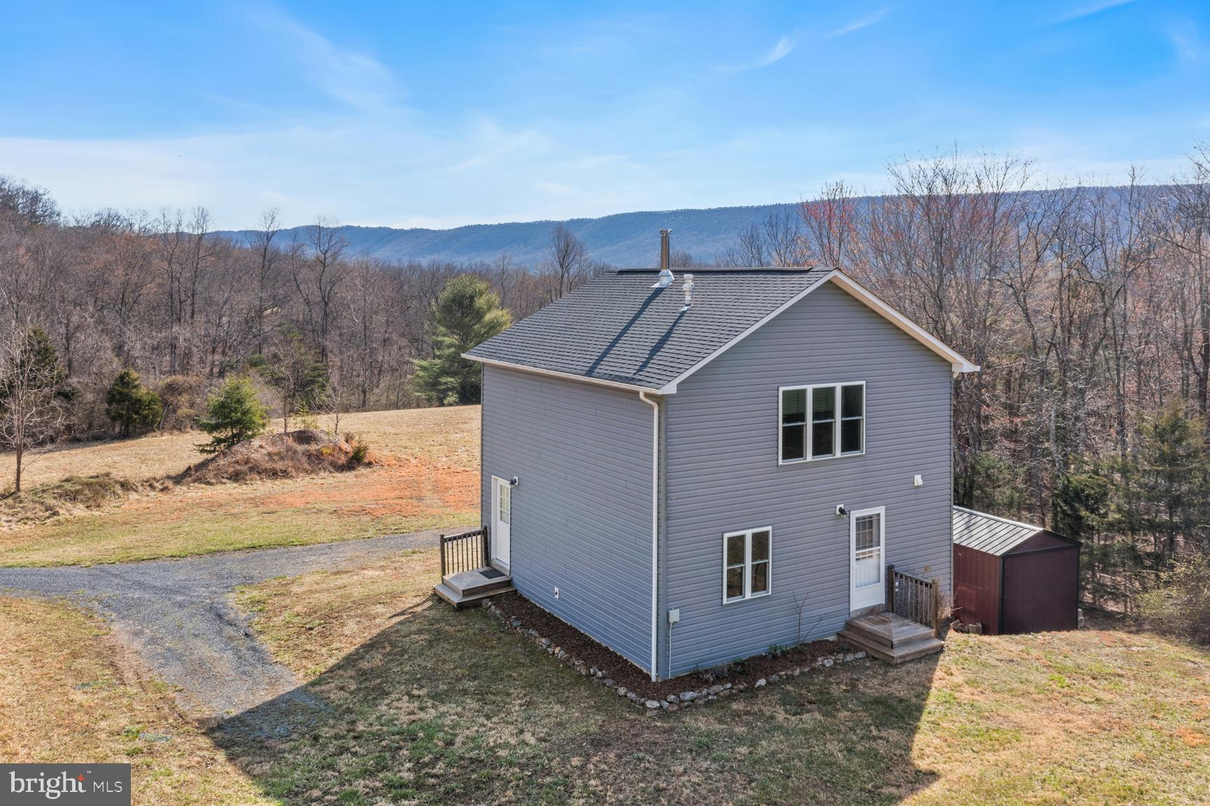 Beautiful Cedar Creek Valley paradise! This 15+ acres includes year round stream frontage, a buffer of mature woods and open grasslands. Not to mention views and privacy.  Built in 2016, this home has all the comforts yet with a minimalist feel.  Lots of windows to enjoy the natural sunlight or starry skies at night,  central HVAC system and wood burning stove for additional heat source, main level bedroom and full bath plus spacious loft area for extra sleeping space or an in-home office!  There's also a full basement with storage area and laundry.  Conveys with storage building and generator!   The land is zoned conservation and the shared driveway traverses the stream.  So many possibilities! - downsize your indoor living for outdoor living, start your own homestead, come for weekend relaxation or  consider the air bnb potential.