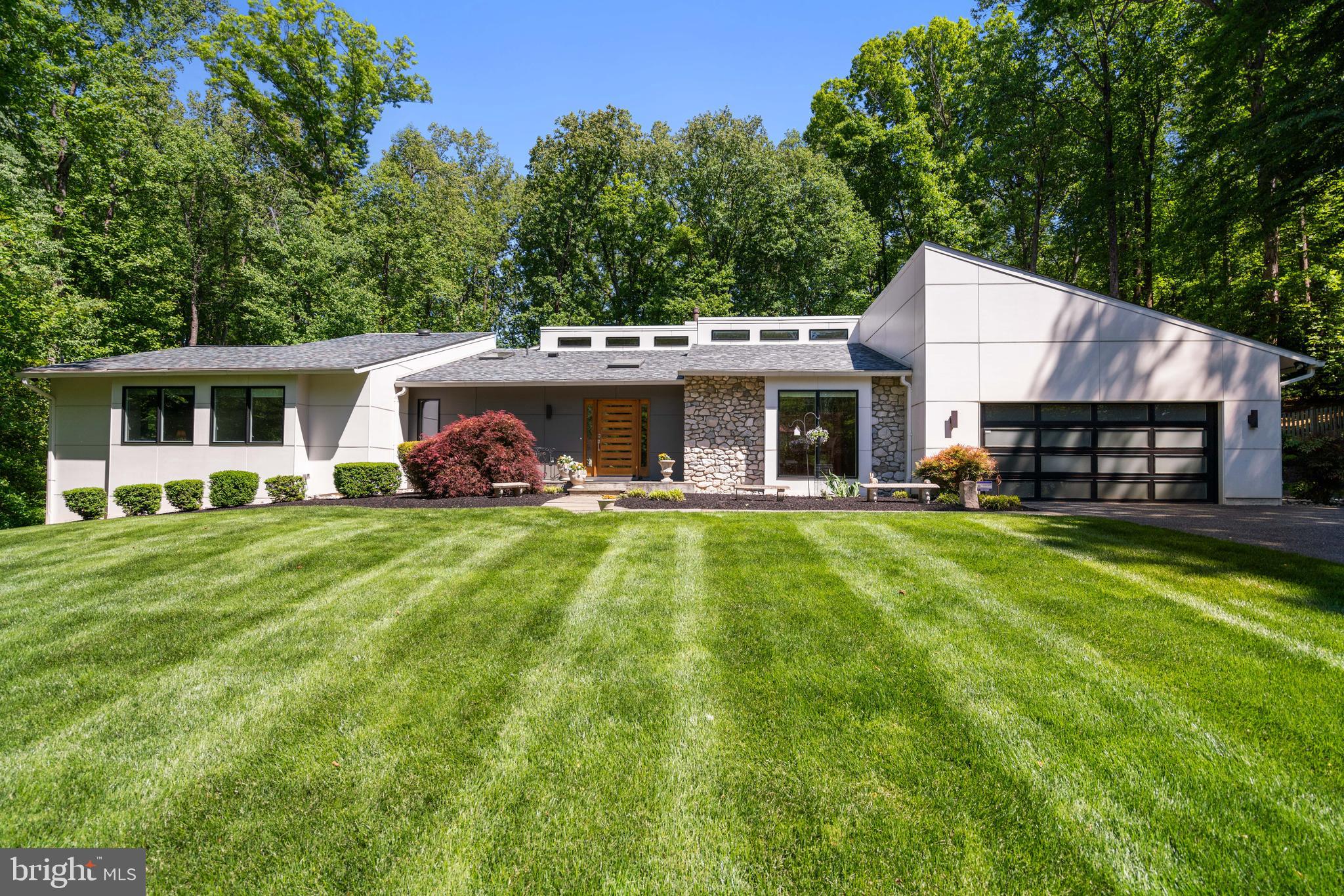 Tucked away on 1.7 private acres overlooking the fairways of Congressional Country Club, 6825 Capri Place offers a lifestyle rarely found in close-in Bethesda — a true retreat from the pace of everyday life, while remaining moments from the conveniences, commuting routes, and amenities that define the area. Set within the sought-after Palisades neighborhood, this distinctive residence blends modern design, natural surroundings, and resort-style outdoor living in a way that feels both elevated and deeply livable.

Designed to embrace its setting, the home’s connection to the outdoors is felt throughout. Two screened porches create peaceful spaces to start the morning with coffee, unwind at the end of the day, or gather with friends while overlooking the beautifully landscaped grounds. At the center of the backyard experience is the impressive 44-foot heated saltwater pool and spa, complete with an electric cover and expansive patio areas that transform the property into a private resort-like sanctuary. Surrounded by mature landscaping and scenic golf course views, the outdoor spaces offer exceptional privacy and year-round enjoyment.

Inside, more than 6,900 square feet of thoughtfully updated living space balances warmth, character, and functionality. Vaulted ceilings, skylights, slate flooring, hardwood floors, and striking stone fireplaces create a home that feels architecturally unique while remaining comfortable and inviting. The renovated kitchen serves as the heart of the home, designed for both everyday living and effortless entertaining with oversized gathering spaces, high-end appliances, extensive cabinetry, and seamless access to the outdoor living areas.

The primary suite is its own private escape, featuring a wood-burning fireplace, direct access to the backyard, and a secluded screened porch overlooking the tranquil setting. Three additional bedrooms and expansive lower-level living spaces provide flexibility for guests, recreation, fitness, or work-from-home needs.

Adding to the home’s appeal is its location within the Walt Whitman High School cluster.

What truly sets 6825 Capri Place apart is the feeling it creates — a home that lives like a private estate, quietly removed from the hustle and bustle, yet incredibly connected to downtown Bethesda, Washington, D.C., major commuter routes, and everyday essentials. Distinctive in both design and setting, this is a rare opportunity to own one of the neighborhood’s most memorable and lifestyle-driven properties.