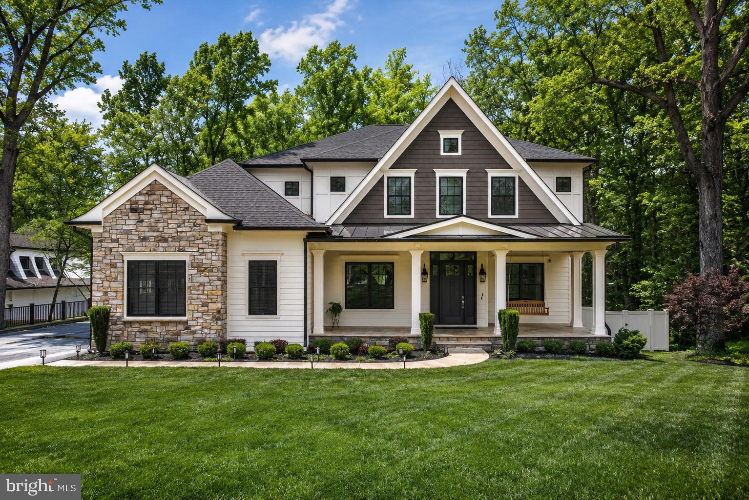 Completed in 2022 and nestled in the sought-after Langley Forest community, this exceptional residence seamlessly blends grand entertaining spaces with comfortable everyday living. Filled with natural light and thoughtfully curated finishes, the home offers elegant yet inviting interiors throughout.

A gracious foyer opens to formal living and dining rooms, while the stunning family room features a striking fireplace and French doors leading to an expansive rear deck overlooking the private backyard with a gas fire pit and built-in grill connection. The chef’s kitchen is centered around a dramatic Silestone quartz island and includes custom cabinetry, professional-grade appliances, a farmhouse sink, and sunny breakfast room.

The main level also features a private study with 12-foot ceilings and a guest suite with full bath. Upstairs, the luxurious owner’s suite offers three walk-in closets and a spa-inspired bath with heated marble floors, dual vanities, and an oversized glass shower. Three additional ensuite bedrooms and a conveniently located laundry room complete the upper level.

The walk-out lower level includes a spacious recreation room, media room with tiered seating, two fitness rooms, and a flexible bonus room with full bath and private entrance. Additional highlights include a large flat backyard, three-car garage with dual EV chargers, whole-house generator, and elevator-ready construction—all just minutes from Tysons Corner, premier shopping and dining, and both Reagan National and Dulles International Airports.