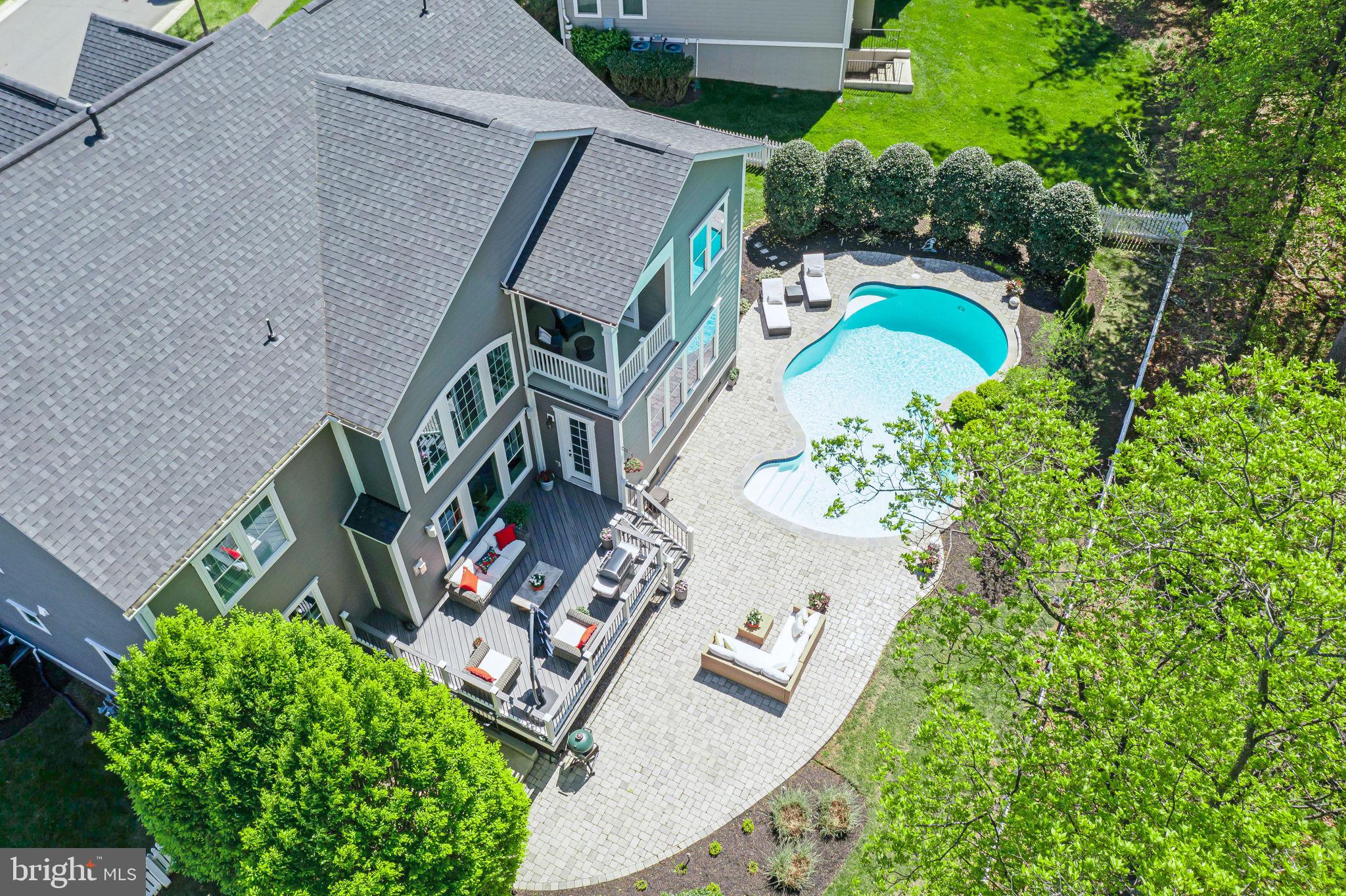 Welcome to your dream home in Willowsford – The Grange, one of Ashburn, VA’s most prestigious and picturesque communities!

This stunning Chapel Hill II by NV Homes, perfectly positioned with a Northeast-facing front, is the ultimate blend of luxury, comfort, and thoughtful design. From the moment you step inside, you'll feel the warmth of a truly special home—a place where every detail has been carefully curated to inspire joy, relaxation, and effortless living.

Upstairs, you’ll find four spacious bedrooms and three full baths, all centered around convenience and comfort. The laundry is right where it should be—on the upper level—making everyday life a little easier.

The primary bedroom? It's an absolute oasis. Vaulted ceilings, cozy yet classy vibes, and a private sitting area that opens directly to your back deck—perfect for sipping morning coffee while gazing out at your very own 8-foot deep pool paradise. The primary bathroom is just as serene, with elegant tilework, soothing color choices, and high-end finishes including a deep soaking tub for bubble baths after long days, and a walk-in shower featuring a luxurious, upgraded glass door.

Back on the main level, the heart of the home comes alive with a gourmet kitchen that belongs on a magazine cover—or a TV cooking show! Think luxury white cabinets, upgraded countertops that sparkle with sophistication, and an extended island that makes the whole space feel like home. Whether it’s a casual brunch or a lively family dinner, this kitchen invites everyone to gather.

Adjacent to the kitchen is a flowing floor plan with a formal dining room, a cozy sitting area, and a jaw-dropping family room with soaring two-story ceilings, coffered details, and oversized windows that flood the space with natural light. Hardwood floors sweep across both the first and second levels, tying everything together with timeless elegance.

Working from home? You’ll fall in love with the dedicated office, featuring double French doors and custom built-ins that elevate the space into one of elegance and luxury—a perfect blend of productivity and sophistication.

And there's more: a double staircase for both convenience and grandeur, a mudroom that actually makes coming home feel luxurious, and built-ins and trim work that show an exceptional attention to detail—from the coffee nook to the butler’s pantry and beyond.

Then there’s the lower level, which honestly feels like its own retreat. Call it a club level or call it the basement—either way, it's amazing. With the most plush, high-end carpet, your guests will instantly feel at home. You’ll love the full wet bar, perfect for entertaining, a dedicated media room, a private gym, and even a legal bedroom with a full bath for overnight guests or in-laws.

Let’s not forget the bumped-out breakfast room that extends the lower level, creating extra space and natural light for those lazy Sunday mornings.

This home has every upgrade imaginable, wrapped in style and functionality. Living in Willowsford – The Grange also means access to farm-to-table lifestyle amenities, scenic trails, community events, and one of the most beautifully planned neighborhoods in Northern Virginia.