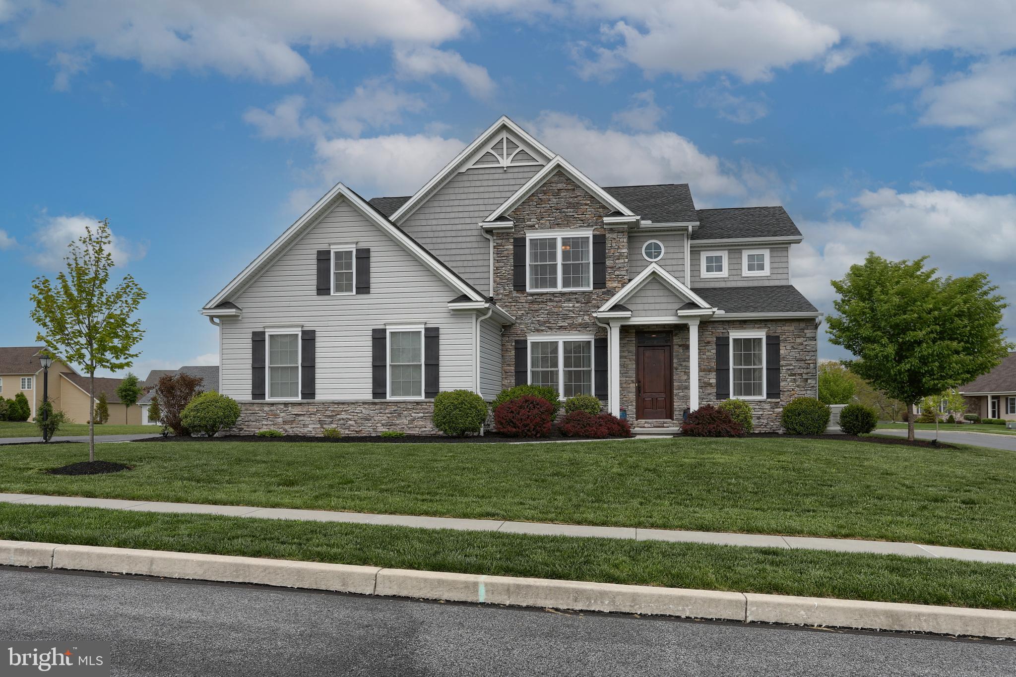 Don't miss the opportunity to tour this delightful Yingst built home set on a lovely, beautifully landscaped  corner lot in the desirable Brook View Development!  Tasteful decor and loads of special features await your discovery here including 9 ft. ceilings and rounded wall corners on the first floor, quartz counters in the kitchen & all baths, Generac whole house generator, and more.  Super functional open floorplan is ideal for entertaining as well as day to day living.  Glass French doors off the foyer lead into a first floor office/study - a quiet and ideal space for working remotely from home.  Kitchen features quartz counters, tile backsplash, island, upgraded stainless steel appliances, tile floor, and roomy dining area.  Spacious family room, open to the kitchen, features a beautiful stone gas fireplace.  Spacious owner's suite boasts two walk-in closets and a luxury bath with soaking tub, tile shower and double vanity w/quartz counter tops.  Ceiling fans in all BR's add to comfort level.  A very nicely finished lower level features a 2nd gas fireplace, professionally installed Hi-Def home theatre speakers in ceiling and walls, full bath, great built-ins and loads of additional living space.  Screened porch off kitchen with patio beyond provides delightful outdoor living space in mild weather.  There's much to love and appreciate about this warm and inviting home - definitely one for your must see list!!
