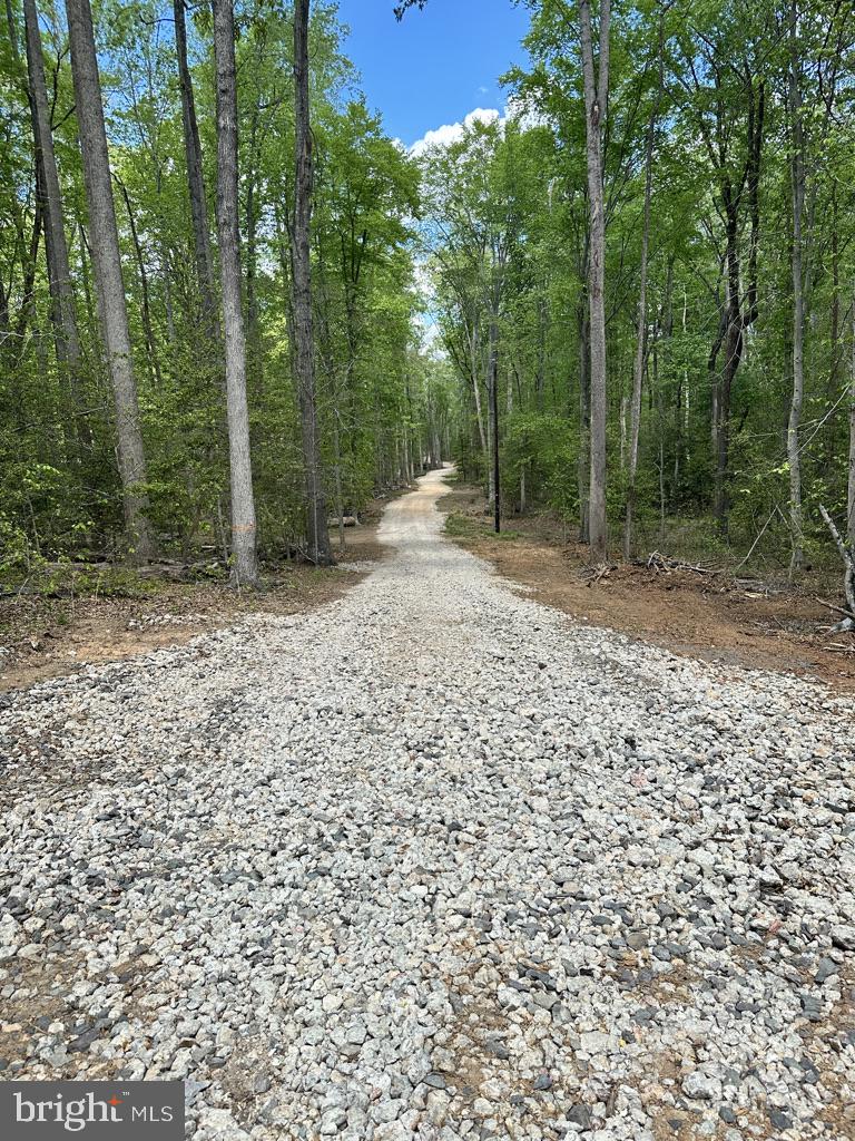This beautiful Lot is a 5 Acre Rural Retreat with mature hardwood trees!  OUR LENDER HAS FINANCING FOR LAND WITH 20% DOWN, AS WELL AS CONSTRUCTION LOANS WITH 0% DOWN FOR VA, AND 3.5% DOWN FOR FHA .  CONVENTIONAL CONSTRUCTION LOANS HAVE JUST 5% OR 10% DOWN.  MAKE YOUR DREAM A REALITY!!  The driveway and house site have been cleared!  The entrance has been graveled to house site.  950' of silt fence has been installed.   This lot is ready to go to build your dream house here with NO HOA.  Within the Spotsylvania County Schools, this area would attend Chancellor Elementary, Ni River Middle and Riverbend HS.  Conveniently located to shopping, commuter lots, restaurants, and entertainment.  If you like water sports, the Hunting Run Reservoir dock is just 5 minutes from here.  For kayakers, there are 3 put ins and take outs on the Rapidan or Rappahannock Rivers just 10 minutes drive from the property.  Surrounding National Battlefields provide plenty of miles of hiking, biking and history!     Soil Study done by M&M Consultants in Documents section.  Perks for a 3 Bedroom semi-conventional septic system but with a modest upgrade, will perk for 4 BR.  See documents for boundary survey, foundation soil report by Geo Terrain, Dominion Energy Easement agreement and other important information.