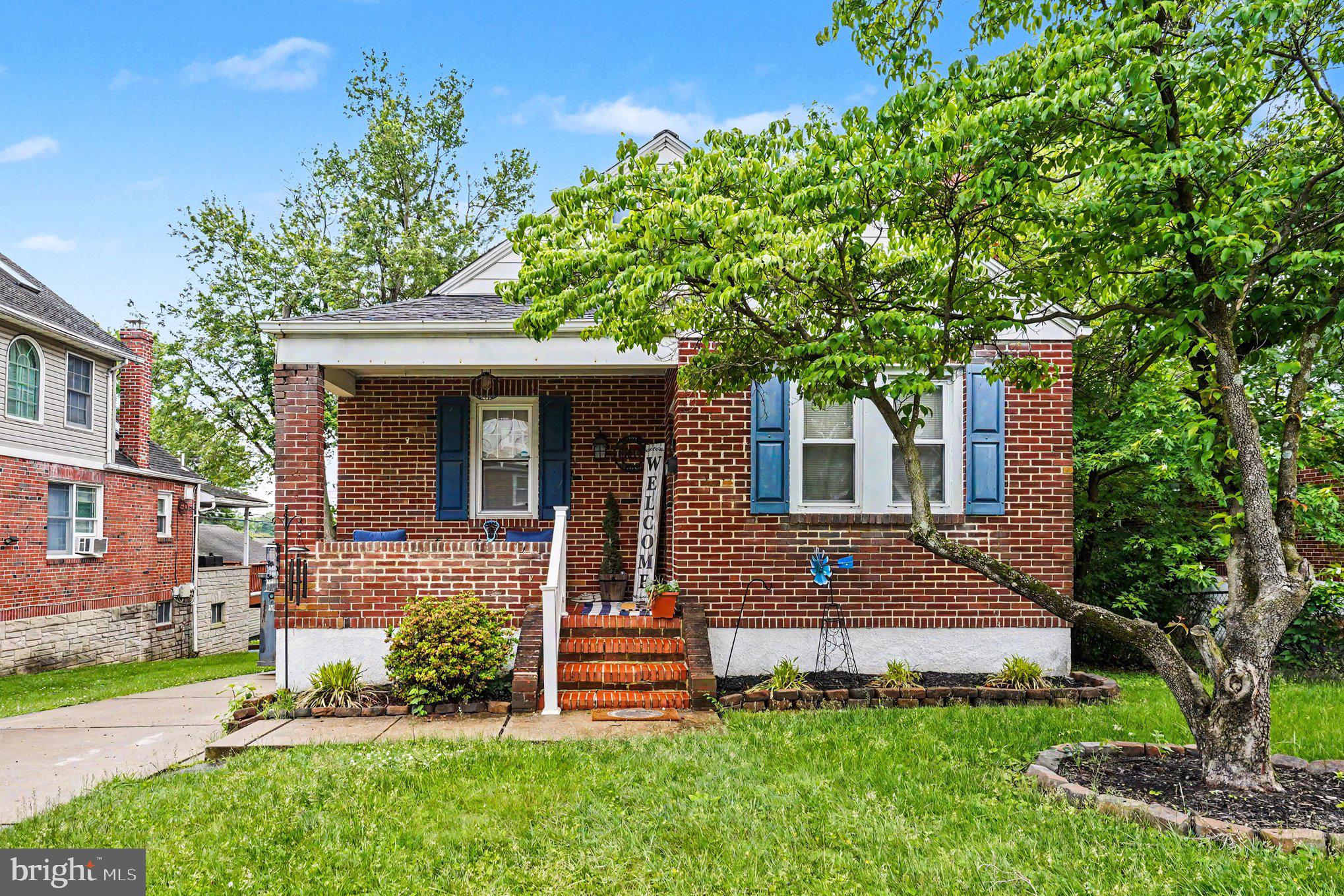 Welcome home to this porch front Brick home!  Walk in to the cozy living room with fireplace focal point (non-functional) with hardwood floors, transition into the dining room that leads to a galley kitchen with new stainless steel gas stove and refrigerator!!  2 main Floor bedrooms and an updated full bath!!!  Off the kitchen is a multifunctional Sunroom that leads to an updated Deck and fenced Yard!!  Upstairs is a huge Bedroom and bonus area!! Lower Level is unfinished but lots of space and leads to a single car garage with rear entry!! House has a long driveway and lots of on street parking available!!  Roof 2024. HVAC 2015, water heater 2015, Fence 2021!!