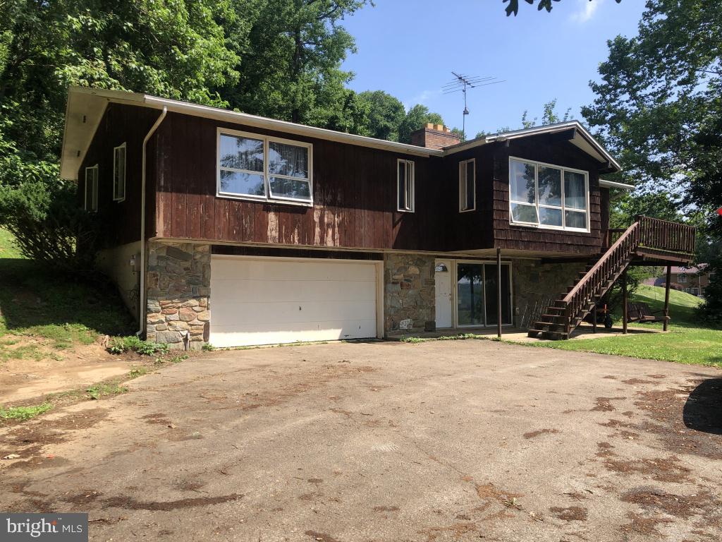 This property will be offered at Public Auction on Thursday, July 23, 2026 @ 6pm.  The listing price is the opening bid only and in no way reflects the final sale price.  10% down due at auction, 2% transfer tax to be paid by the purchaser, real estate taxes prorated. Nestled on a beautiful country lot, this 
property offers a peaceful setting and a home designed for comfortable everyday living. The home features a spacious living room with a fireplace, a dining room, a kitchen with access to the deck, a laundry room, and a main-floor bedroom with access to the attic. The second floor offers two additional bedrooms, a full bathroom, and a convenient half bath. The partially finished basement includes a family room with a wood-burning fireplace, providing additional living and entertaining space. Additional highlights include a deck overlooking the backyard and an attached two-car garage. This well-maintained property offers comfortable living spaces, ample storage, and a convenient location, making it an excellent place to call home.
