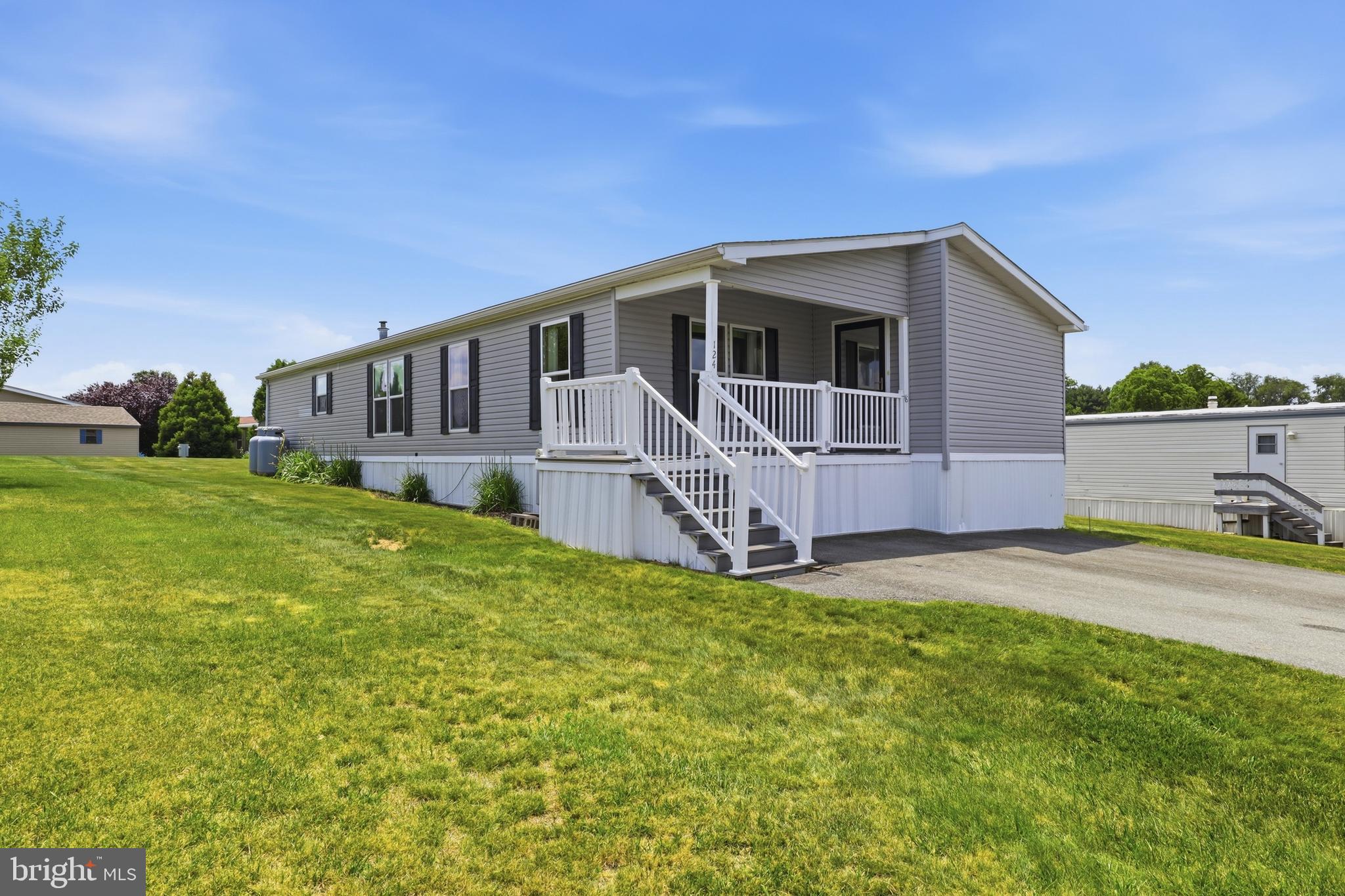 Welcome to low-maintenance living in the Yorkanna Mobile Home Park 55+ community! This well-maintained double-wide manufactured home offers the convenience of true first-floor living with 3 bedrooms and 2 full baths.
Step inside to a spacious, sun-filled living room featuring an abundance of natural light; perfect for relaxing or entertaining. The full kitchen offers generous countertop space, ample cabinetry, and a cozy eat-in dining area. Even better, all appliances convey with the home, making your move seamless.

Toward the rear of the home, you’ll find a practical mudroom with washer and dryer included adding everyday convenience right where you need it. 

The primary suite is a comfortable retreat, complete with a walk-in closet and a private bathroom featuring a double sink vanity. The two additional bedrooms are both nicely sized and include closets.

Enjoy your morning coffee or unwind in the evening on the inviting front porch with durable composite decking. Outside, there are two driveway parking spaces and a storage shed, providing plenty of room for tools, hobbies, or seasonal items.

Lot rent is $555/month and includes sewer and trash.

If you’ve been looking for comfort, convenience, and community all in one place, this home checks the boxes.