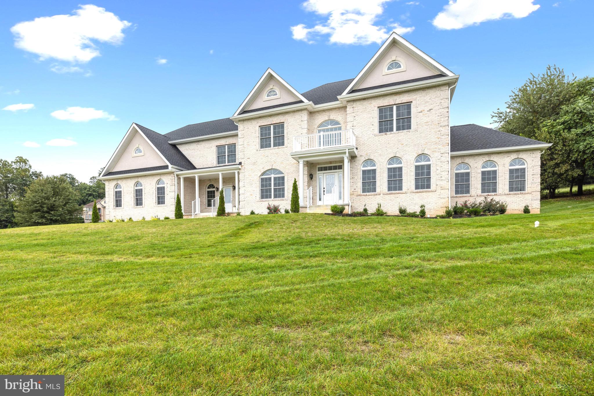 Motivated seller - price reduced! Construction just completed on this NEW luxury residence, offering everything a buyer could want, in an exclusive ten-home community with large rolling lawns and similar luxury homes. In  a prime location near downtown Damascus and I-270, the home is sited on a cul-de-sac, and is approached via a long driveway leading to the impressive white brick property with three-car garage. The home enjoys a wonderful open floor plan and the house spans approximately 9,750 total square feet on three fully finished levels. The main entrance to the home leads to an impressive two-story Foyer with sparkling chandelier and sweeping curved staircase. A large Living Room accommodates guests, as does the generous Dining Room with wainscoting and designer lighting. Ten foot ceilings, hardwood floors and fine trim work combine to make these rooms special. The outstanding Chef's Kitchen reflects the latest in kitchen design, with an oversized center isle, plenty of cabinetry, gorgeous quartz countertops and backsplashes, designer fixtures, extra ovens, recessed Kitchen Aid refrigerator and beverage cooler.  A Breakfast Room is adjacent to the Kitchen, lined with windows, providing access to the rear yard. At the center of the home is the large Family Room with fireplace. A Library nearby can easily be used as a main level Bedroom with a nearby Half Bath. The Sunroom is a wonder with walls of Palladian windows! Two staircases lead to the Upper Level of the house. A sumptuous Primary Bedroom Suite provides plenty of space for a sitting  area, and offers two very large walk-in closets. The Primary Bath is very special, with a freestanding tub, shower and beautiful quartz tile. Three additional large Bedrooms are on this level, as well as two Full Bathrooms. There is also a separate Laundry Room.  The Lower Level is a world onto itself, with a walk-up entrance and window wells letting in light throughout. A large Recreation Room comes with a Bar area with frig and sink. The Media Room is ready to go! The 6th Bedroom is on this level, as is the Fourth Full Bath, a gym and utility room housing the two zones of HVAC for the home. Outside, a rolling front yard provides a beautiful setting to the one-acre lot, and a patio in the rear is available for dining al fresco, with privacy provided by a row of trees. A conservancy area abuts the back of the property. This is a one-of-a-kind home and not to be missed!