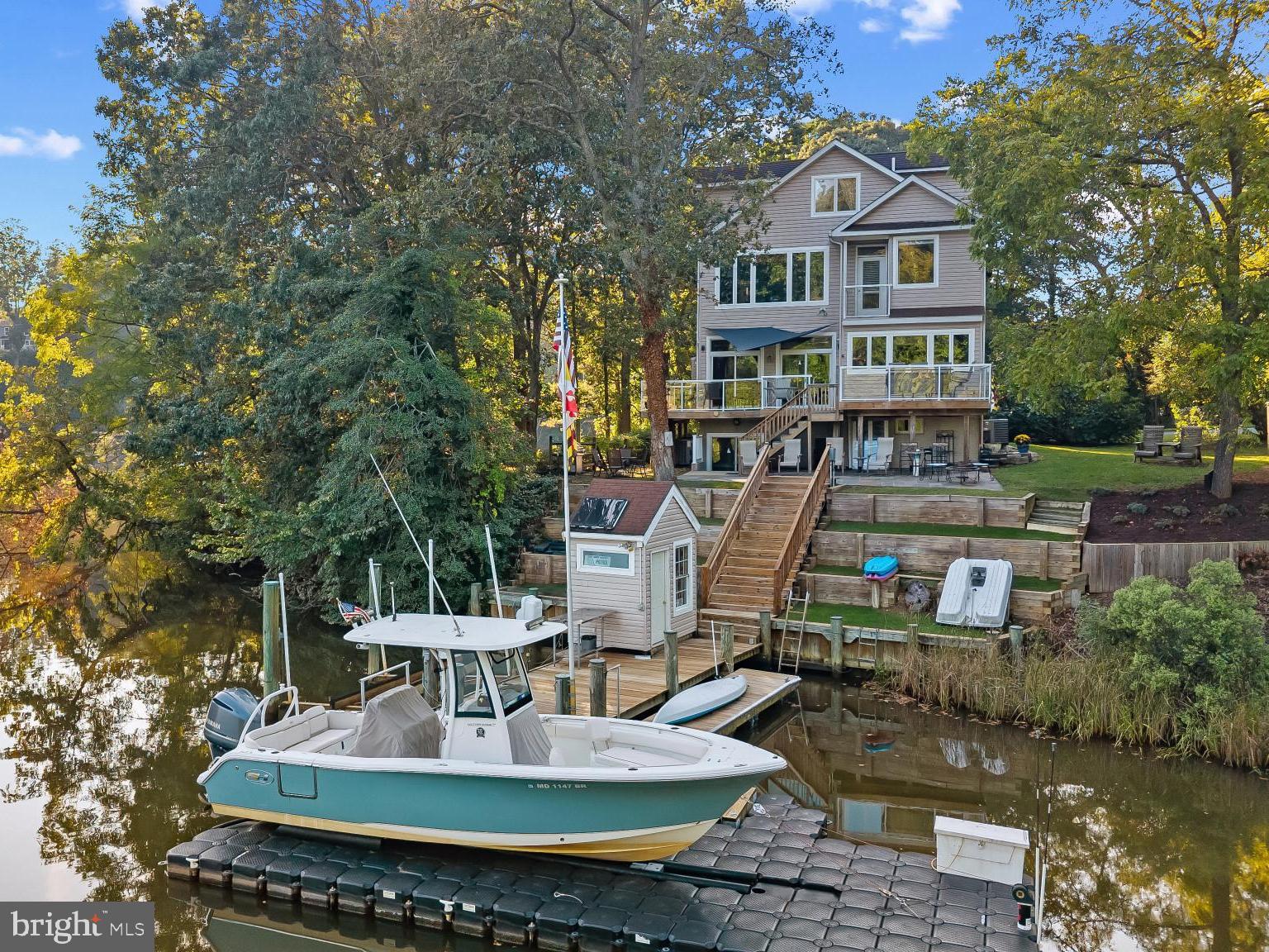 Tucked at the end of a quiet cul-de-sac on the coveted shores of Mill Creek, this exceptional waterfront retreat captures sweeping views that stretch outward to Whitehall Bay and ultimately the Chesapeake Bay, an ever-changing backdrop of light, sky, and water.

The home is thoughtfully designed to embrace its setting, with newly refinished wood floors guiding you through the main level where an open and inviting layout unfolds. The living room and kitchen are perfectly positioned to take in the water views, while a cozy fireplace adds warmth and ambiance. The spacious kitchen serves as the heart of the home, featuring a large center island with seating, generous cabinetry and countertops, ideal for both everyday living and effortless entertaining. 

Upstairs, the primary suite offers a peaceful vantage point over the water, complete with an ensuite bath, private balcony and a serene atmosphere that makes waking up here something special. Two additional bedrooms share a well-appointed hall bath, providing comfortable accommodations for family or guests. The uppermost level adds incredible flexibility, featuring a full bath, charming window seats, and an open space that can easily function as additional sleeping quarters, a playroom, or a relaxed gathering area.

The lower level, with its own private entrance, is designed as a studio-style living space complete with a kitchenette, and full bath, creating the ideal space for guests, in-laws or an au-pair.

Outdoor living is where this property truly shines. A glass-railed deck wraps around the rear of the home, offering a front-row seat to the expansive views and seamless indoor-outdoor living. Below, a stone patio provides an additional space to gather and unwind just steps from the water’s edge. The private pier is exceptionally well-equipped with two lifts, a floating dock, and a convenient storage shed, creating the perfect setup for boating, crabbing, paddleboarding, or simply enjoying life on the water.

With its premier location, versatile living spaces, and captivating views, this Mill Creek property offers a rare opportunity to experience the waterfront lifestyle at its finest. Welcome Home!