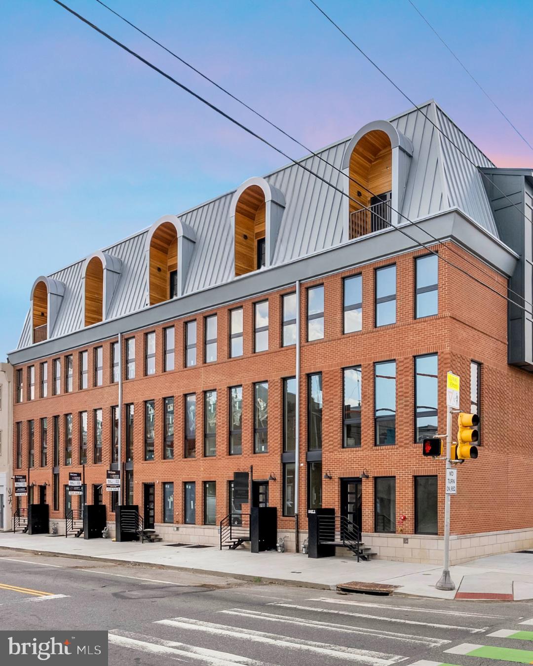Introducing "10 on Eleventh" - a stunning new community, comprised of ten luxury homes ideally situated at the corner of Christian Street and 11th Street in the highly desirable Bella Vista neighborhood of Philadelphia. A premier Philadelphia based Development firm, Hightop thoughtfully designed these homes to offer over 3,200 square feet of refined living space featuring 4 bedrooms, 4 full bathrooms, 2 half bathrooms, 2-car GARAGE parking, ELEVATOR,  and expansive private rooftop decks. Every detail has been thoughtfully considered—from the sleek, modern design to the premium finishes and smart layout. Step inside to find a welcoming entryway that leads to a full bedroom and bathroom on the first level, ideal for guests, an office, or a private suite. Upstairs, the main living level impresses with wide-plank hardwood floors, recessed lighting, and an open-concept layout perfect for everyday living and entertaining. Massive windows throughout let exceptional southern light into the home. The gourmet kitchen features high-end custom cabinetry, stainless steel appliances, quartz countertops, a large island with barstool seating, and a designated dining area. A stylish powder room is tucked conveniently off the kitchen, just before the spacious living room that anchors the main level. The luxurious owner’s suite boasts large windows for abundant natural light, a walk-in closet with custom shelving, and an elegant bathroom complete with dual vanities, a soaking tub, a linen closet, and a spacious walk-in shower with a rainfall showerhead. Two additional bedrooms—each with their own private bathrooms and generous closet space—round out the upper floors. Before heading to the rooftop, you’ll pass a sleek wet bar perfect to entertain your company. The private rooftop terrace offers ample space for dining, lounging, or even a hot tub—perfect for relaxing or entertaining. A finished basement adds valuable bonus space and includes a half bathroom. Each home includes a 10-year property tax abatement and a 1-year builder’s warranty. Located in the heart of Bella Vista, residents will enjoy easy access to some of Philadelphia’s best amenities. Stroll through the historic Italian Market, grab coffee at Fitzwater Café, or enjoy dinner at Dante & Luigi’s or The Saloon. South Street’s shops, bars, and restaurants are just around the corner, while Center City, Washington Square West, and Old City are all within walking distance. With convenient access to major highways and public transit, getting around the city is effortless. Taxes are not $1. Taxes and square footage is the responsibility of the buyer to have verified independently. Photos are of the model home and may not depict actual finishes.