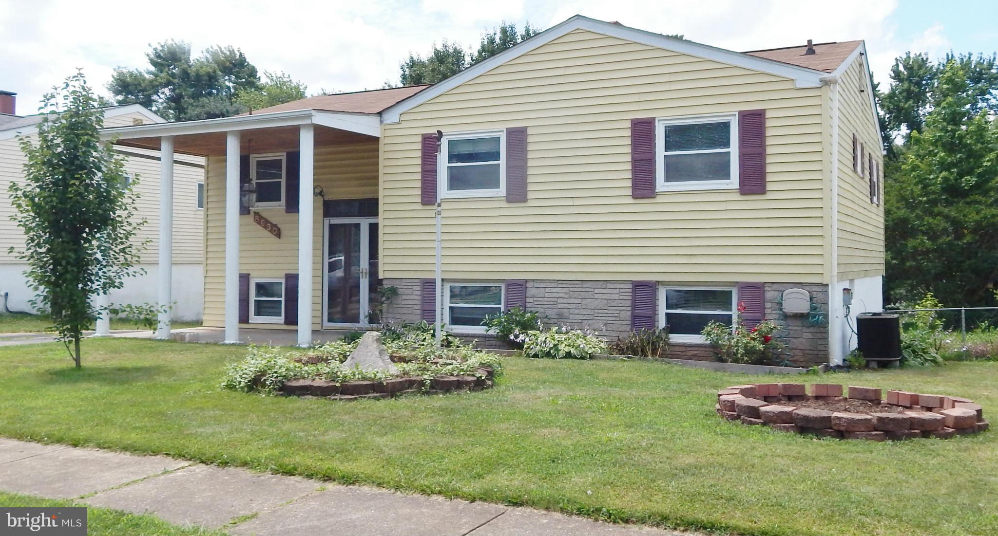 Pack your bags, YOU are HOME!  This Spacious Split Foyer offers Updated Kitchen and Bath, Hardwood Floors throughout, and Open Floor Plan.  Finished Lower Level with Family Room, 4th Bedroom and Full Bath. Dining area  Sliders lead to covered Deck overlooking fenced yard, and lower level  walks out to patio. Newer windows and Bow window in the Living Room brings in lots of natural light.