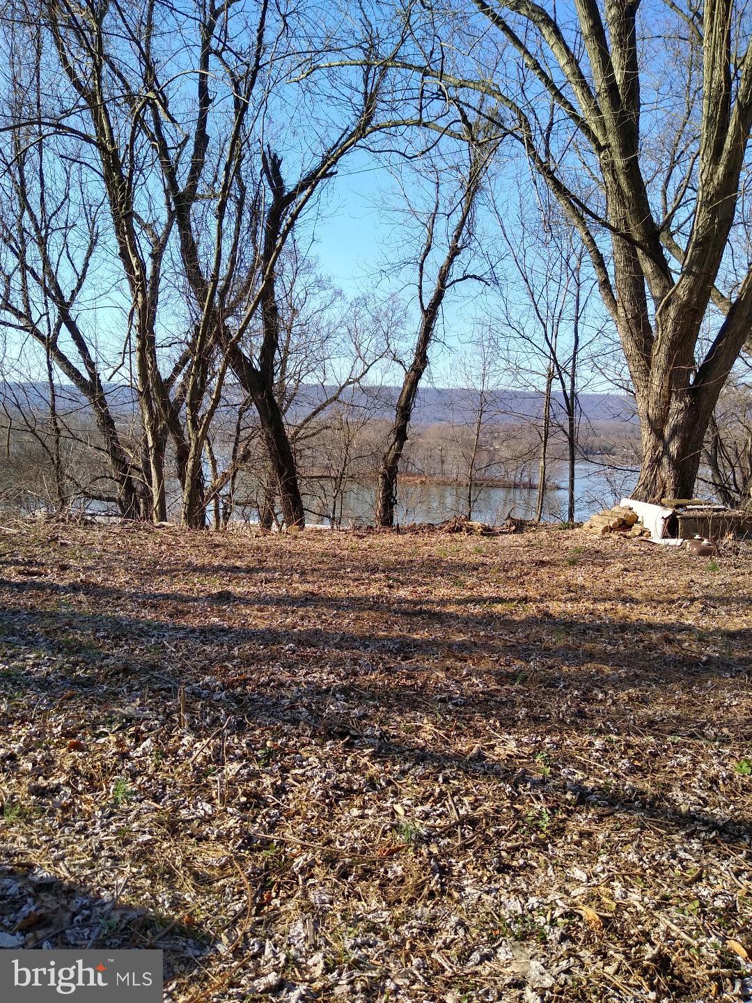 Located just off PA-15 in Perry County, this 0.20-acre residential parcel offers a rare opportunity to own land with stunning views of the Susquehanna River and surrounding mountains—all for just $10,000! The lot features a tiered layout with a flat, cleared upper section and a lower rear portion approximately 15 feet below, both offering potential for panoramic vistas. No utilities are currently on site, but the neighboring property has active hookups, making future development more feasible. Ideal for investors, weekend adventurers, or buyers seeking a peaceful retreat, this property combines natural beauty with strategic location near Duncannon and the Clarks Ferry Bridge, which connects to US-22/322 for regional access. With low taxes and rising land values in Perry County, this parcel presents a compelling long-term investment at an unbeatable entry price. From Harrisburg, take US-22 W/US-322 W across the Clarks Ferry Bridge to PA-15 N. Follow PA-15 N toward Duncannon, then turn onto State Rd. Property is approximately half a mile on the right. For GPS, use 1020 State Rd—the lot is directly next to it.