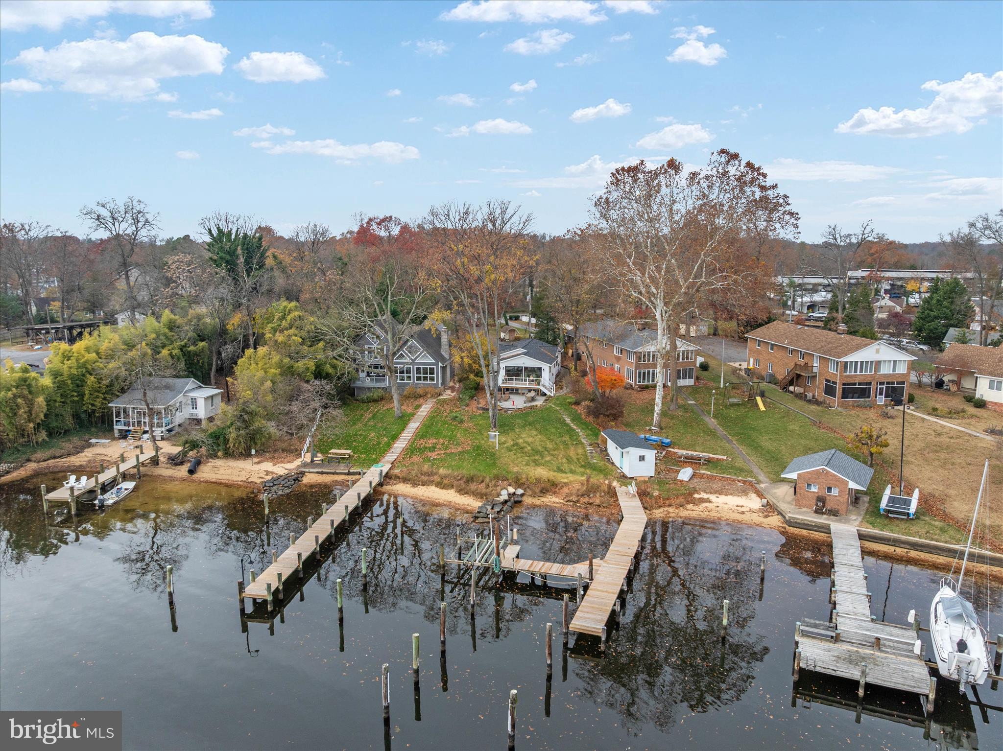 Wake up to expansive views of the Magothy River from this completely renovated Coastal Cottage in the Severna Park community of Magothy Beach!    Deep water (8' +MLW) with boat lift on updated pier,   Step inside to discover the water views from both levels,   Open layout offers a great room with gas fireplace for the upcoming chilly weather, a chef's dream kitchen with abundance of cabinetry, quartz countertop, tiled backsplash & deluxe s/s appliances including 5 burner gas stove and 9' island for ample seating plus separate dining room with custom lighting,  Sliders lead to waterside deck  for relaxing while taking in the tranquil view, that steps down to custom patio for additional dining/grilling & entertaining space, Two bedrooms with custom details and two luxuriant bathrooms with tiled showers/baths , HVAC is electric with propane gas backup (1 yr), Architectural roof (1 yr), Windows & doors (1) LPV throughout  with exception of custom-tiled bathrooms , Lower level boasts an oversized family room  for additional gathering and entertaining space, a bar/entertaining area and half bath (with RI full bath connection should you wish to reconvert back to full bath).   Ample storage in the unfinished portion of LL as well as two outdoor storage outbuildings including a shed and waterside storage for your toys or equipment, Lawn sprinklers on waterfront side, Public water/sewer, Severna Park school district, Flood insurance not required, HOA paid as part of taxes