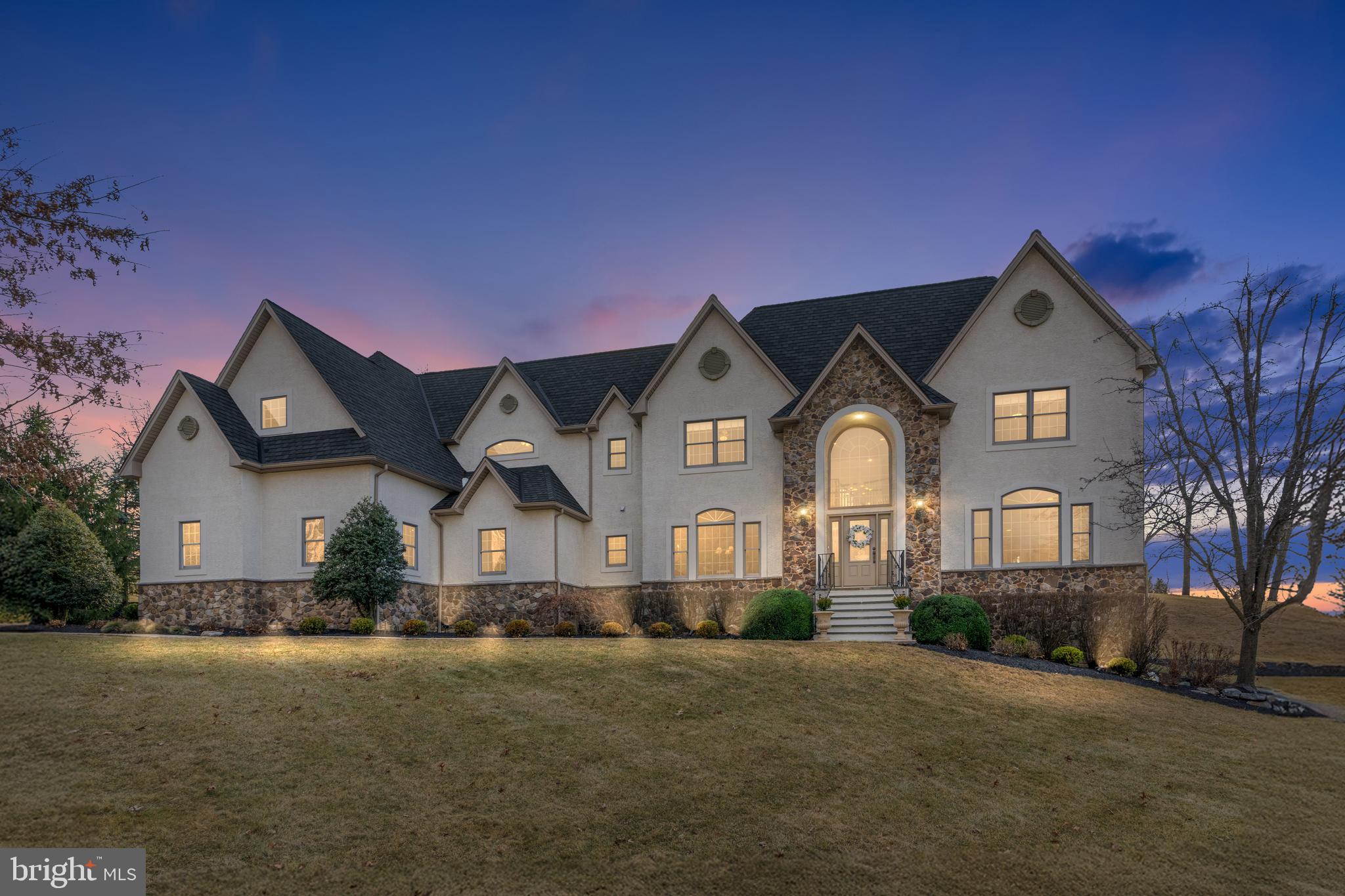 Set in the prestigious SADDLE RIDGE community of SAUCON VALLEY, this exceptional estate is a triumph of luxury, sophistication, and architectural brilliance. Boasting over 7,400 sq. ft. of exquisite living space, this residence is designed for the most discerning buyer. Every inch exudes refinement, from the new GOURMET KITCHEN—an entertainer’s dream outfitted w/ top-tier appliances & custom cabinetry—to the masterfully curated interiors designed by SERENA & LILY. A newly installed designer shingle roof, new flooring & a fully renovated lower level elevate the home’s elegance. Wellness & relaxation take center stage in the expansive home fitness center. The sophisticated walk-in WINE CELLAR invites you to indulge in the finest vintages, perfect for connoisseurs & gatherings. Additionally, a state-of-the-art security system ensures peace of mind throughout the home. Unparalleled outdoor living awaits w/ a new paver patio, custom GOLF PRACTICE GREEN w/ sand trap & fire pit perched high up for BREATHTAKING VIEWS. A new playground offers family-friendly luxury. Plans & permits are approved for a resort-style pool, this estate is primed for an extraordinary lifestyle. Don’t miss the opportunity to own this rare gem in one of the region’s most sought-after locations. Imagine waking up to breathtaking surroundings, entertaining in grand style & indulging in the finest amenities—all w/in your own private sanctuary. This is more than a home; it’s a statement of prestige & refinement.