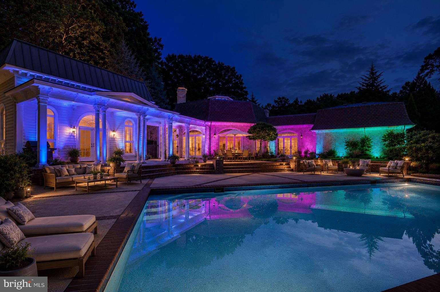 Architectural Distinction and Luxurious Living in Potomac Falls! Welcome to an extraordinary opportunity to own a one-of-a-kind residence nestled in a serene cul-de-sac-like setting in prestigious Potomac Falls. Location, Privacy. Set on a quiet, cul-de-sac-like enclave, this exceptional residence offers a rare combination of privacy, scale, and proximity to the region’s most desirable destinations. Originally expanded and redesigned by Robert G. Melby, the home reflects a thoughtful balance of timeless architecture and modern livability. A circular driveway creates a striking arrival experience, leading into interiors defined by soaring ceilings, expansive glass, and seamless indoor-outdoor connection. Natural light fills the home, framing views of professionally landscaped grounds and a resort-style pool. The kitchen is purpose-built for both daily living and large-scale entertaining, featuring dual islands, professional-grade Sub-Zero refrigeration, an integrated wine storage system, and extensive custom cabinetry. Labradorite blue granite countertops add a distinctive, high-end finish. The lower level includes a dedicated home theater with custom finishes, offering a private, cinema-quality experience. Outdoor living is equally well-considered. A columned breezeway connects to a two-level pool house with three full baths—ideal for guests, extended stays, or private retreat space. Despite its secluded setting, the property remains highly connected—just minutes from Bethesda, Tysons Corner, McLean, Georgetown and Capital Beltway —delivering both convenience and discretion. This is a rare offering for buyers seeking architectural character, functional luxury, and a prime location.