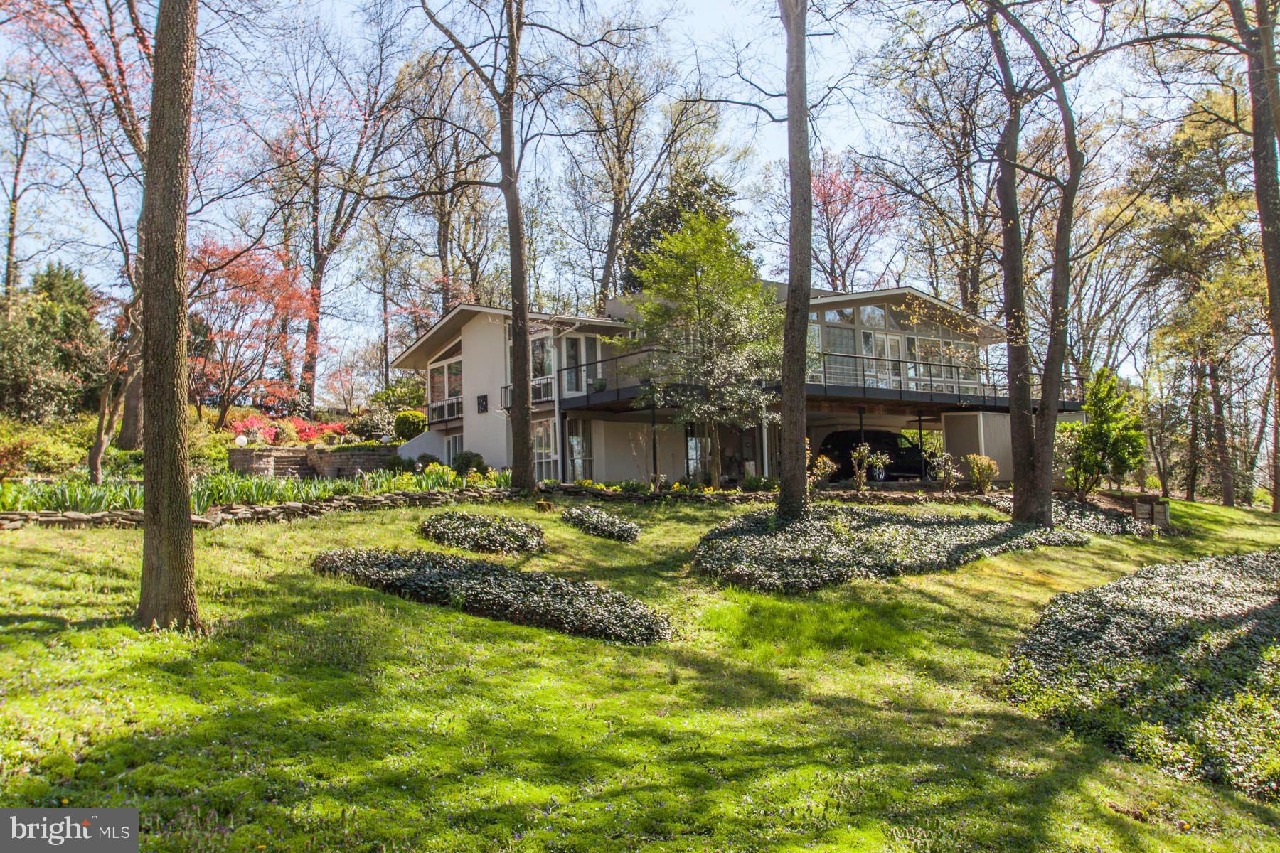 Two and a Quarter quiet country acres just a 10 min drive along the river from Old Town Alexandria & Reagan National.  Features European style kitchen, 6 BR, 3BA, large Master Shower w/steam, several decks overlooking mountain type views, hot tub, gunite pool and covered parking for 3+ cars.  R-2 zoning allows potential for additional building sites.