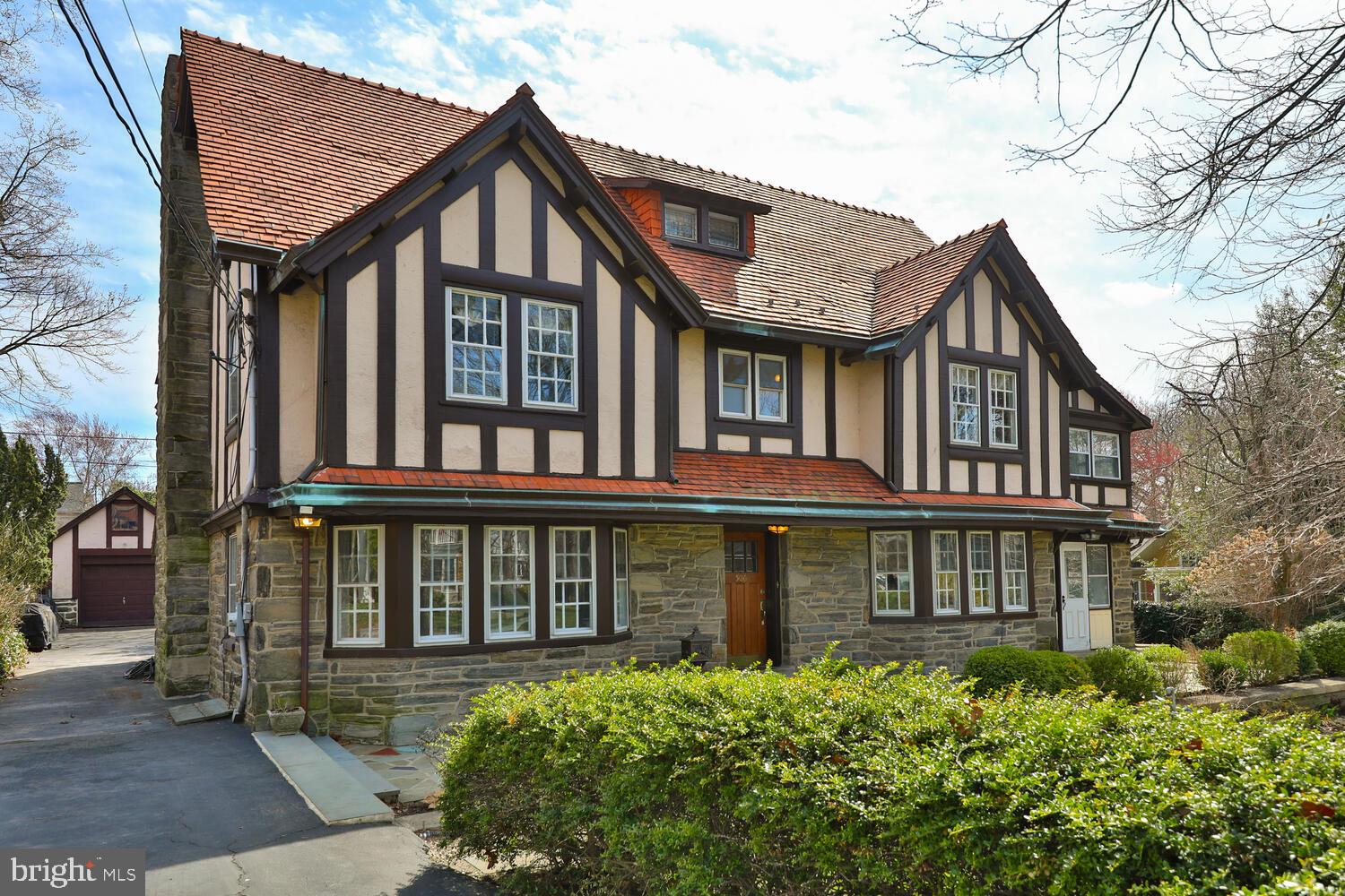 Stunning Tudor Home in Merion Station

Step into a piece of history with this magnificent Tudor home, lovingly maintained by the same owner for over 40 years. Nestled on a picturesque lot, this residence boasts an impressive façade, a generous front yard, and a charming front patio adorned with intricate tilework. A side driveway leads to a spacious detached garage with a finished attic for additional storage.

Upon entering, you are welcomed by a classic foyer that sets the tone for the home's elegance. To the left, a formal dining room easily accommodates 10-12 guests, perfect for hosting unforgettable gatherings. To the right, the grand living room features original built-ins, a stately fireplace, and two sets of French doors opening to a sun-drenched sunroom.

The expansive kitchen is a chef’s dream, offering a large center island, wine cooler, hand wash sink, and an adjacent powder room. Off the kitchen, an additional sunroom boasts stunning backyard views, creating a serene space filled with natural light.

Ascending the staircase, the second floor features two master suites, two additional bedrooms, and a bright sunroom with wraparound windows, inviting in abundant natural light. A hallway bathroom and a convenient laundry room complete this level. The third floor presents two oversized bedrooms and a spacious bathroom with a window, enhancing the airy feel of the home.

This home is rich in character, featuring hardwood floors throughout, radiator gas heat, and two-zone central air conditioning for year-round comfort. The lush backyard is a true retreat, boasting two mature magnolia trees, a designated gardening space, a charming patio perfect for al fresco dining, and a flat grassy area ideal for play or relaxation.

Located in the heart of Merion Station, this extraordinary home offers a rare blend of historic charm, modern amenities, and unparalleled space. Don’t miss this incredible opportunity—schedule your private showing today
