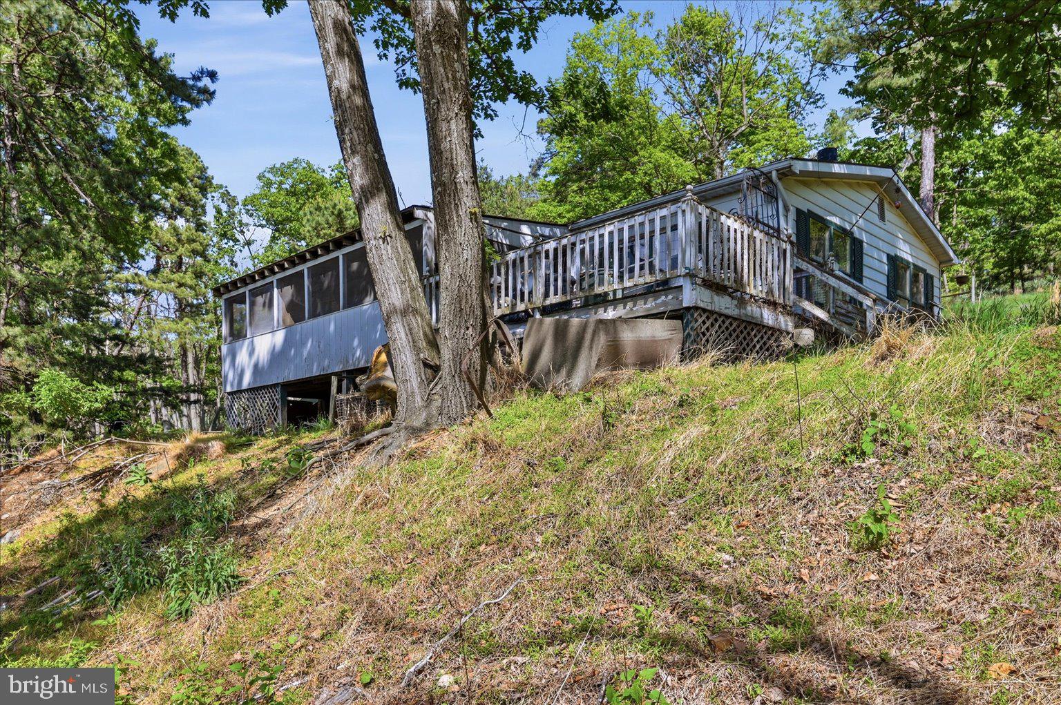 Tucked away in the scenic mountains, this rare 6+ acre property offers the perfect opportunity to create your own retreat. Surrounded by breathtaking mountain views and peaceful privacy, the land provides a beautiful setting for a full time residence, weekend getaway, or investment property. A prior homesite exists on the property and is considered a total rehab and/or tear down, but valuable improvements remain in place including well, septic, and existing utilities, helping simplify the building process. Enjoy the serenity of nature while still having access to nearby amenities. Bring your vision and build the mountain escape you’ve been dreaming of.  ***Due to safety concerns, do not enter the existing structure. ***Access to the home is prohibited.***