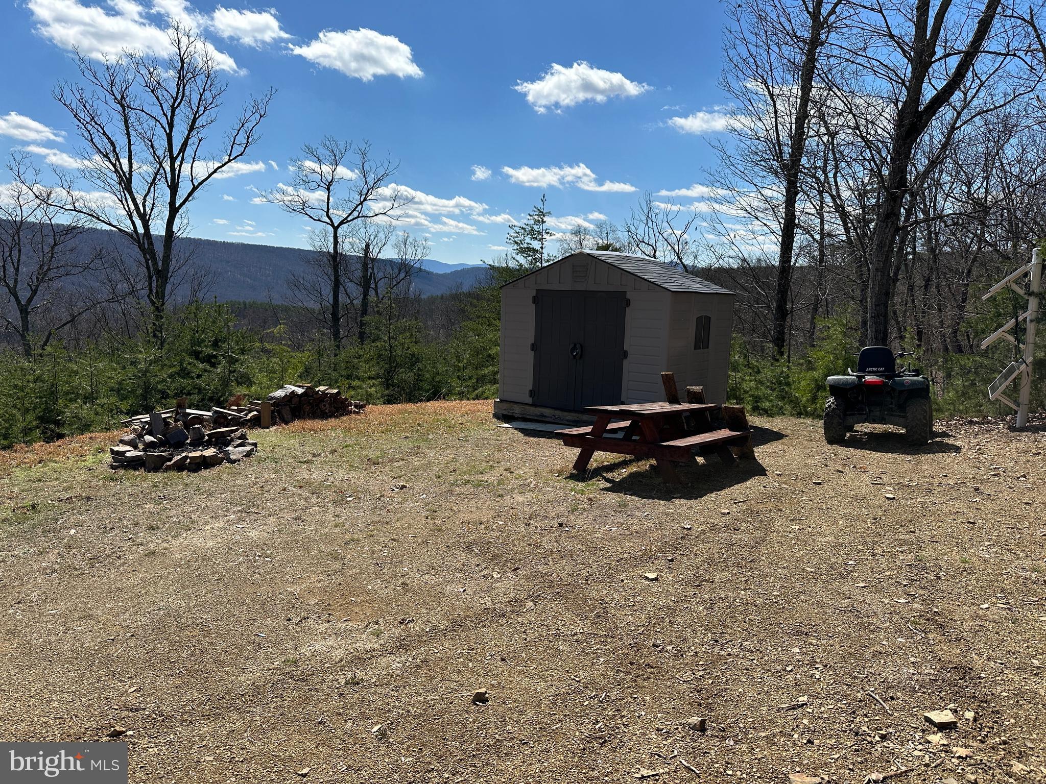 CHECK EVERY BOX ON YOUR LIST......24 WOODED ACRES WITH DRIVEWAY INSTALLED TO BUILD/CAMP SITE WITH STUNNING SOUTHERN VIEWS. COMES WITH GOOD TIMES STARTER KIT: SHED, PICNIC TABLE, FIRE RING & SOLAR PANEL BANK FOR SMALL CAMPER OFF YOU WANT TO STAY OFF GRID. EASY TO BUILD ON, POWER & PERKED, ELECTRIC 200 YARDS FROM BUILD SITE.....YOU'RE AT LEAST 10K AHEAD OF THE GAME ON INFRASTRUCTURE COSTS WITH THE DRIVEWAY & CLEARING ALREADY DONE. AWESOME TREE HOUSE/HUNTING BLIND IN PLACE, STAY OUT OF THE COLD WHILE YOU'RE WAITING FOR MR. BIG TO WALK BY. SMALL WET WEATHER STREAM WITH MULTIPLE WATERFALLS & OVER 1/2 MILE OF ATV TRAILS ON THE PROPERTY. LOCATED IN THE PRESTIGIOUS GATED COMMUNITY OF "THE BLUFFS ON THE POTOMAC".....THE BLUFFS IS KNOWN FOR IT'S ABUNDANCE OF BIG BUCKS, BEAR & TURKEY. AS AN ADDED BONUS, THE COMMUNITY HAS IT'S OWN PRIVATE COMMON AREA ON THE SOUTH BRANCH OF THE POTOMAC RIVER FOR CANOE, KAYAK, TUBES, FISH & SWIM......A PRIVATE PARK ON THE RIVER FOR YOUR SUMMERTIME ENJOYMENT. BUILD, CAMP, HUNT, HIKE, ATV'S, SHOOT......ENDLESS OUTDOOR ACTIVITIES AT YOUR FINGERTIPS.....A STUNNING PROPERTY THAT'S READY TO ENJOY....THIS PROPERTY IS SURE TO CHECK EVERY BOX ON YOUR LIST!