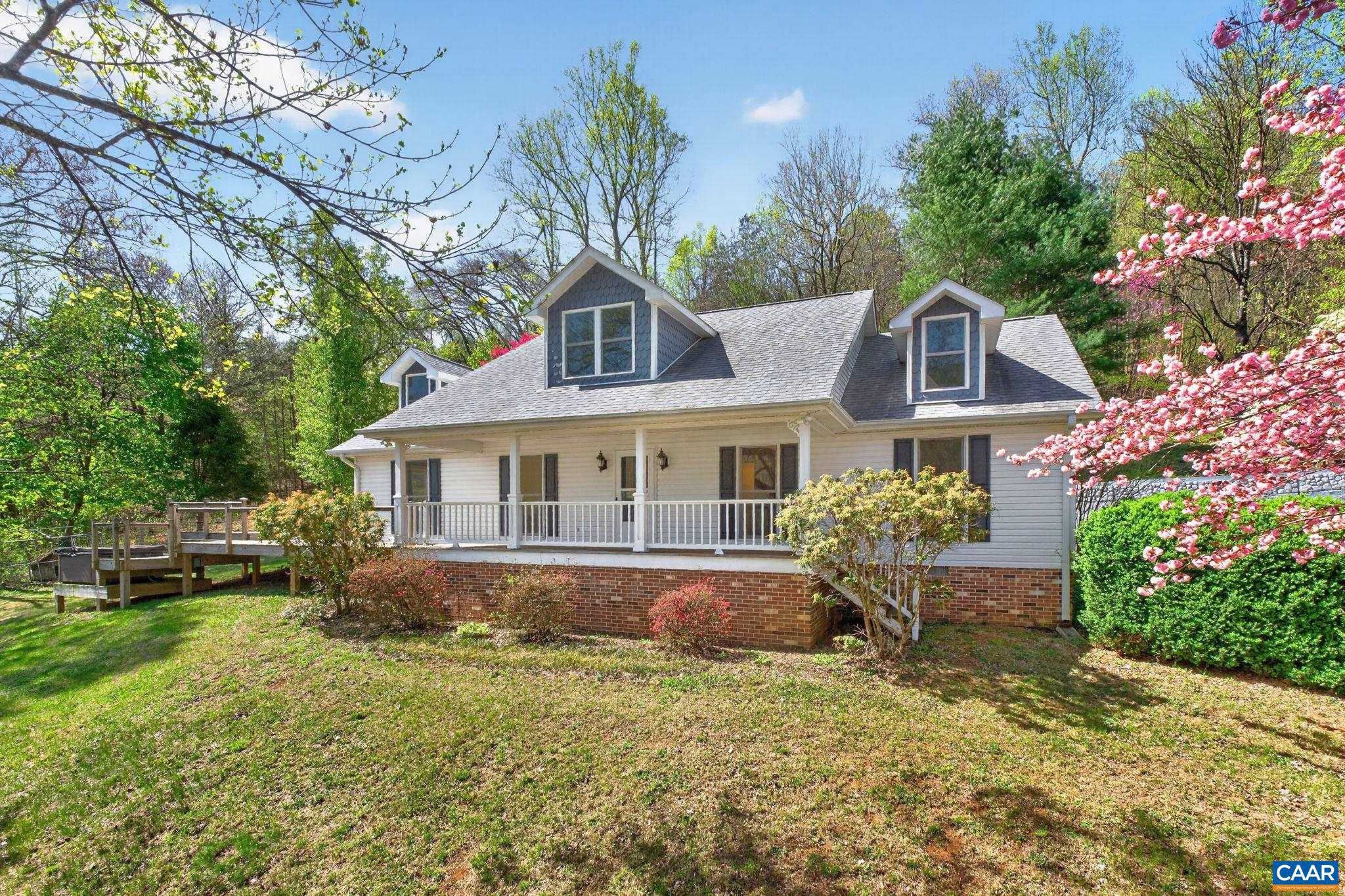 Nestled in the foothills of the Blue Ridge Mountains, this beautifully maintained home offers peaceful living with scenic mountain and water views. The landscaped grounds feature extensive hardscaping and seasonal blooms, best enjoyed from the expansive front porch or multi-tiered deck with hot tub. Inside, a bright, vaulted living room welcomes you with abundant natural light, hardwood and tile flooring, and detailed trim throughout. The main level includes a spacious eat-in kitchen, sunroom (ideal as a dining space), a remodeled hall bath, a primary suite, and two additional generously sized bedrooms. Upstairs, an enormous bonus room with a full bath, complete with a massive tile shower with stack stone accents, provides flexible living space.  Recent updates include a new roof, multi-zone HVAC (3 units, 2?8 years old), and all new windows. Designed for entertaining and easy living, don't let this exceptional opportunity pass you by!,Fireplace in Living Room