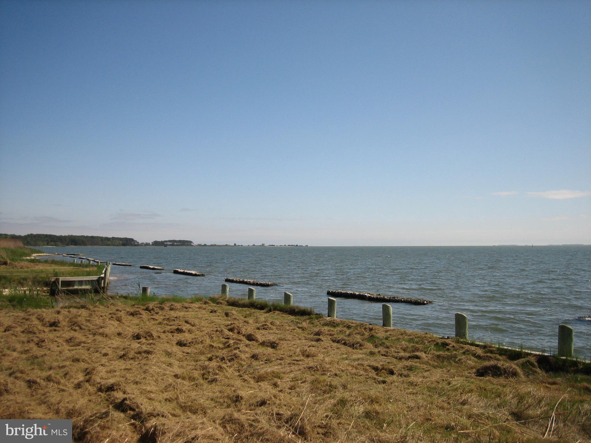 1/748 Direct Chincoteague Bay lot w/ approx 50’ of bulkhead located in Captains Cove.  At this time, there is no water, sewer or electric availability in this area. Lot is currently NOT buildable and sold "AS IS/WHERE IS".. This would be a great place to throw out a line or crab pot. Captain’s Cove is the Eastern Shore of Virginia’s fastest growing Golf & Waterfront community; close to Chincoteague Island, Wallops Island and Ocean City MD. HOA amenities: Pristine 9 Hole Gold Course, indoor/outdoor pools (2), fitness center, basketball, pickle ball & tennis courts, boat ramp, docks, playground, dog park biking & walking trails and so much more. HOA Dues $1874 year. NO tents, campers, trailers, double-wide are allowed in Captains Cove.