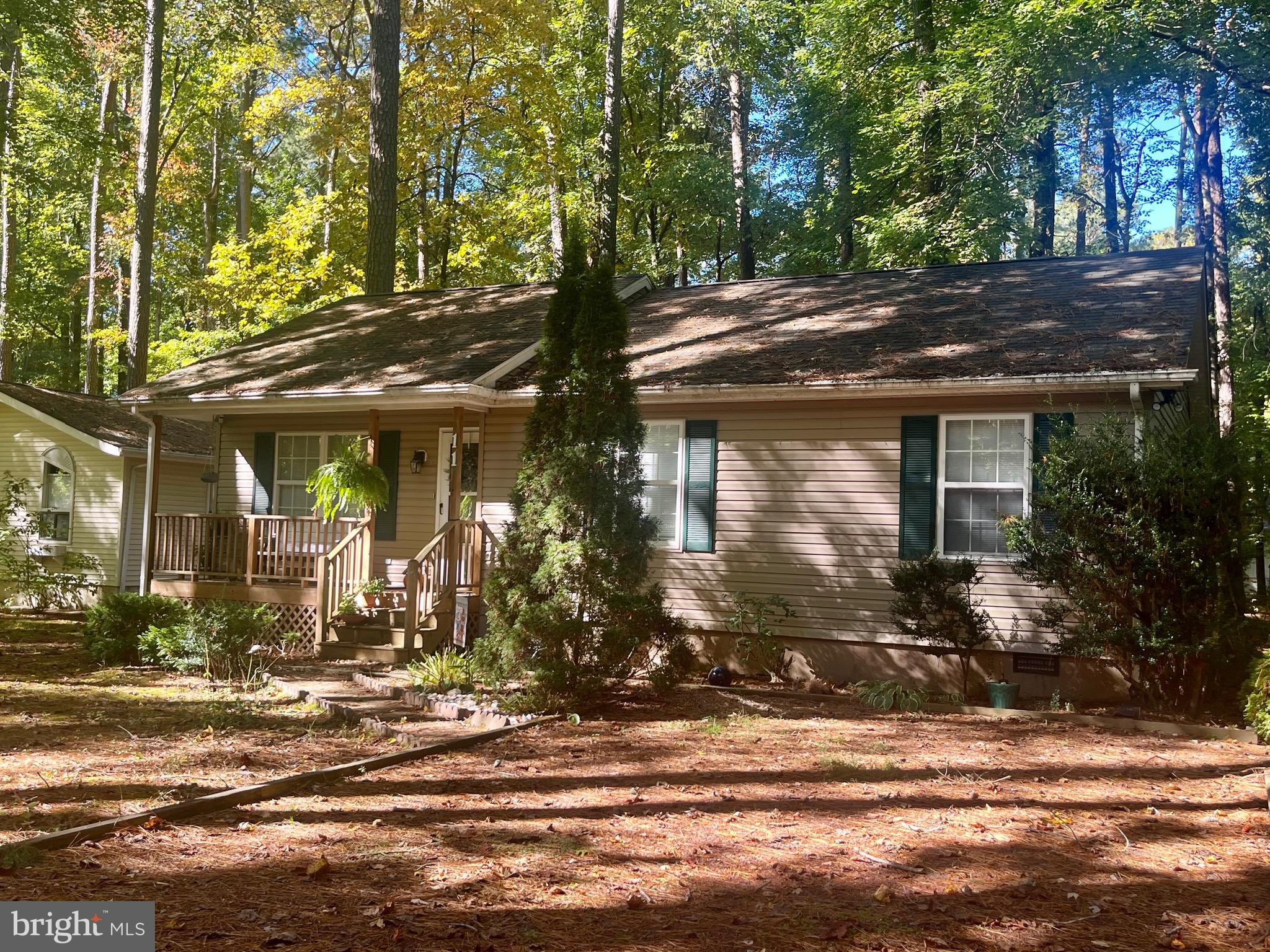 Don't miss this cozy Rancher in Ocean Pines! Open floor plan makes for great entertaining. Cathedral Ceilings in the living room, dining room and kitchen. Gas fireplace. Dining room sliders lead to the screened in porch. Laminate flooring through out the home. Updated kitchen appliances. Breakfast bar. Ceiling fans through out. Primary bedroom with a full bath and sliders to the back patio. Covered front porch.  This home is located just minutes from Downtown  Ocean City  and Downtown Berlin with many shops, restaurants, beach and the bay! Get in and get settled so you can enjoy all the fun before next Summer!