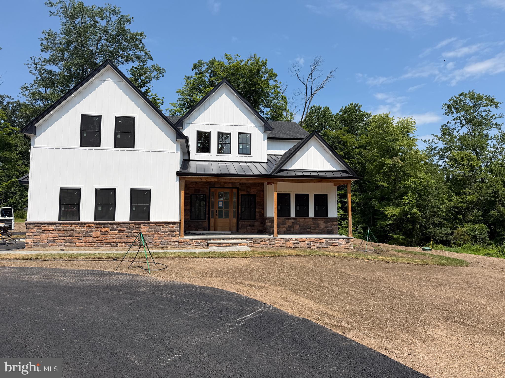 82 Scott Road is a brand-new custom colonial on 3.27 open acres in Bedminster Township, built with the kind of detail that people who actually build things notice immediately. Spray foam insulation throughout. Whole-house generator. Indoor sprinkler system. Ten-foot ceilings on the main level, nine-foot ceilings upstairs and in the finished basement. This is not a production home dressed up with a luxury price tag. It was built to perform.
The main level is designed for real life. First-floor primary suite. A 14x24 kitchen with a pantry that connects directly to the attached garage via a grocery door. Mud room laundry and a second laundry room upstairs. A finished basement with a media room and plenty of storage. Everything has a place and a reason.
Then there is the detached garage. Nearly 1,500 square feet of ground-level bay space across two sections, plus an 800+-square-foot finished loft above; fully heated and cooled with mini splits. A workshop. A studio. A home office that impresses. A car collection that finally has a home. Whatever you need it to be, the infrastructure is already there.
Open acreage, light woods at the perimeter, no HOA, and end of June/beginning of July completion.
If you have been waiting for something built the right way, on the right land, with room to live and work the way you actually want to; this is it.
