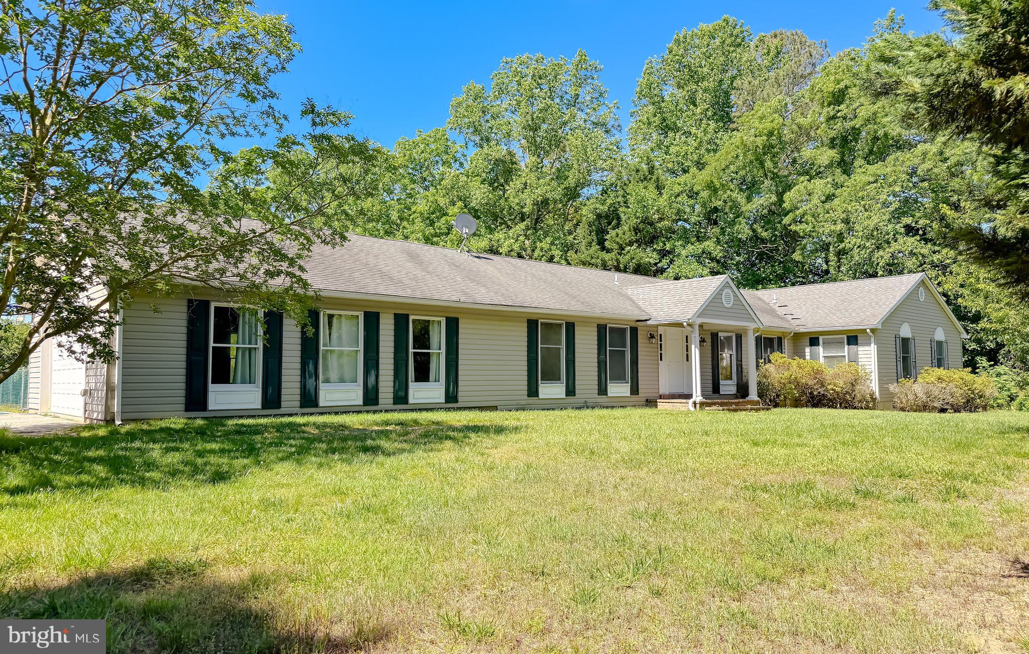 Spacious 4-bedroom, 2.5-bath ranch-style home situated on just over an acre backing to a golf course, offering privacy and scenic views. This home features wood flooring in the main living areas, a formal dining room, and a comfortable living/sitting room with ceiling fans and window treatments. The kitchen includes stainless steel appliances, pantry, and recessed lighting.

The large primary suite offers a soaking tub, double vanities, and two walk-in closets. Three additional bedrooms are generously sized, each with ceiling fans and walk-in closets. Additional features include a laundry room and a convenient half bath.

Enjoy the fenced-in backyard area, perfect for pets or outdoor use, with additional space extending beyond the fence line. Rear deck area previously in place provides an opportunity for customization or future outdoor living space.

Large two-car garage with ample storage. Great setting with room to make it your own! Pictures have been virtually staged.